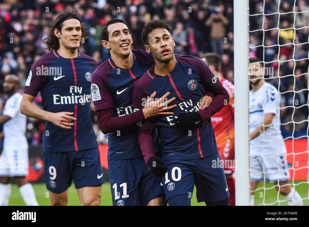 Paris Saint Germain's Neymar Jr (R) celabrates after scoring with teamates  Angel Di Maria (C) and Edinson Cavani (L) during the French Ligue 1 soccer match between Paris Saint Germain (PSG) and Racing Club Strasbourg Alsace at the Parc des Princes stadium in Paris, France, 17 February 2018.  Stock Photo