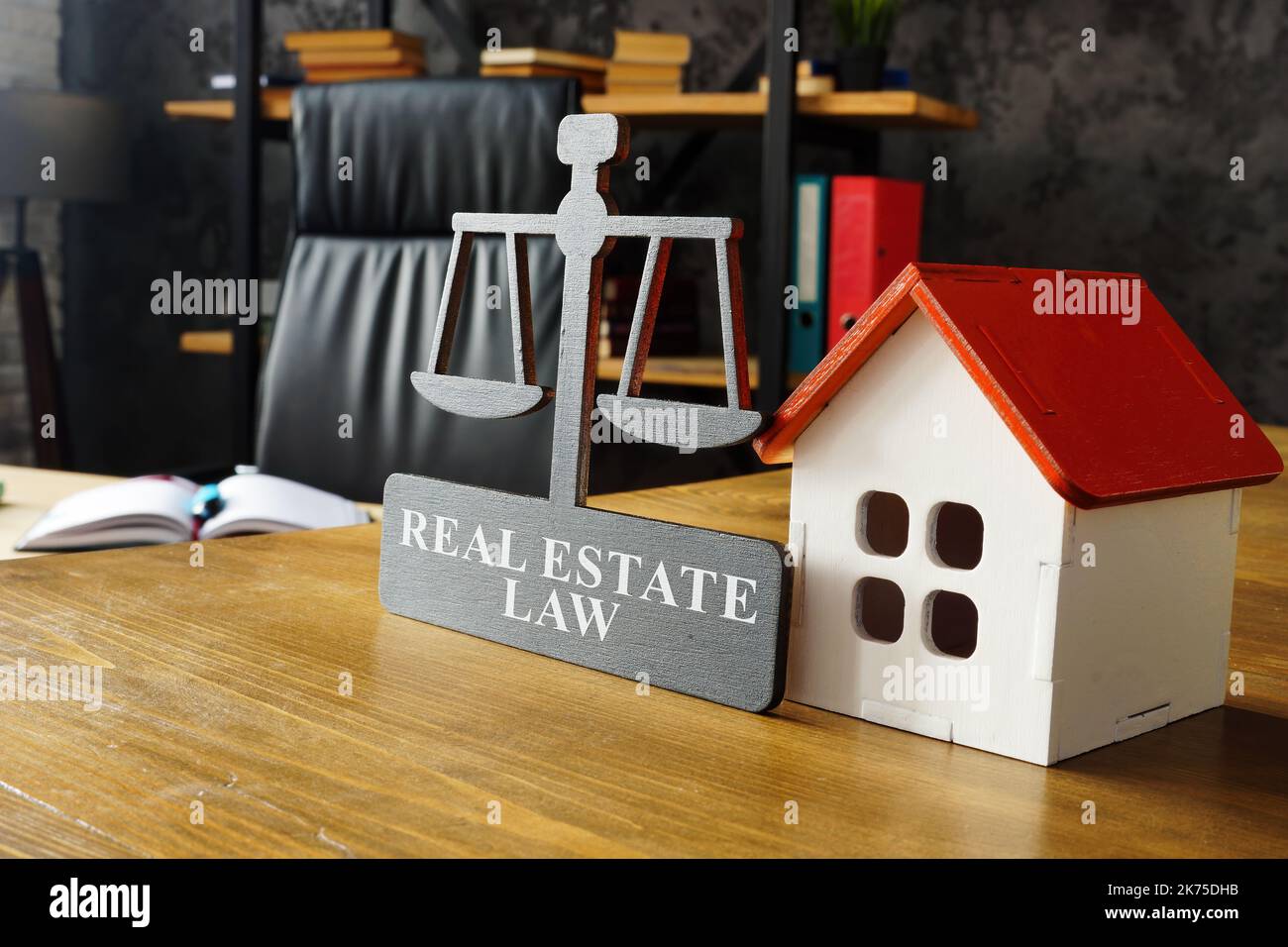 Model of house and real estate law plate. Stock Photo