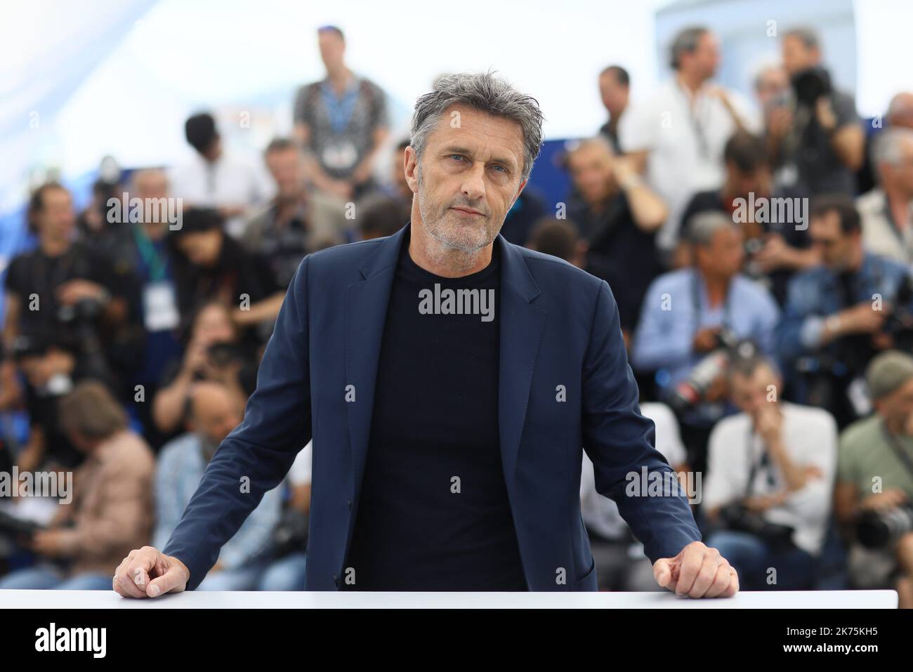 Polish director Pawel Pawlikowski waves on May 11, 2018 during a photocall for the film 'Cold War (Zimna Wojna)' at the 71st edition of the Cannes Film Festival in Cannes, southern France. Stock Photo
