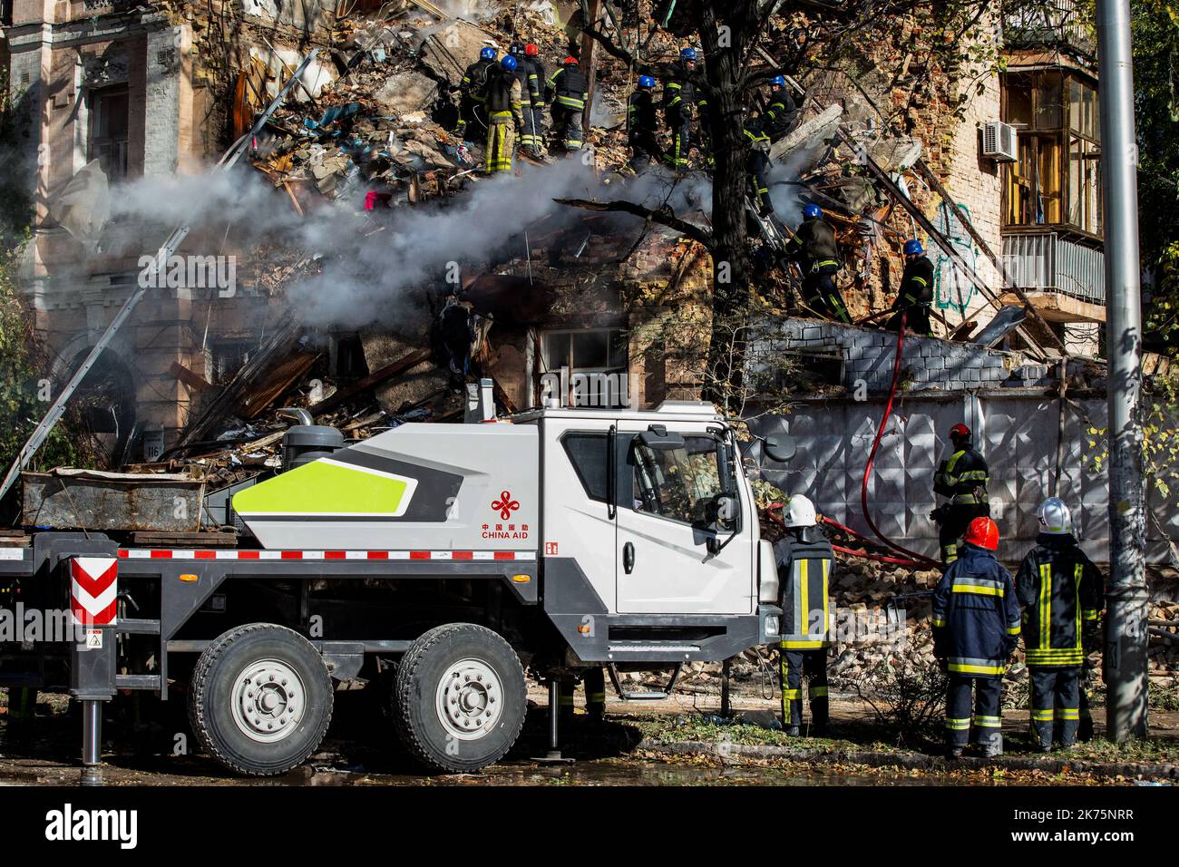 Ukrainian rescuers work at the site of a residential building destroyed