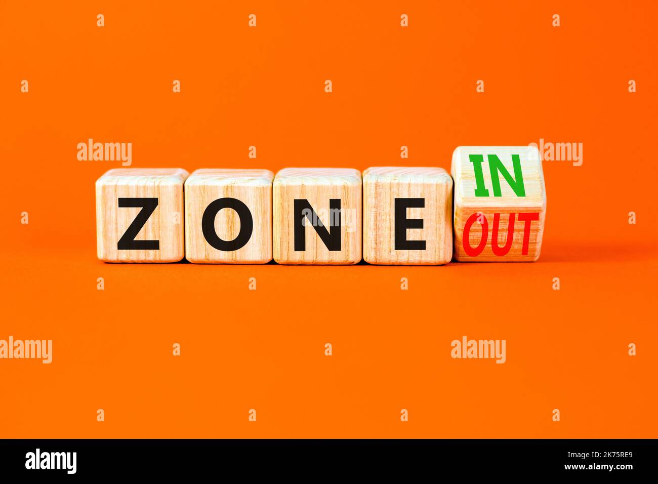Zone in or out symbol. Concept words Zone in and Zone out on wooden