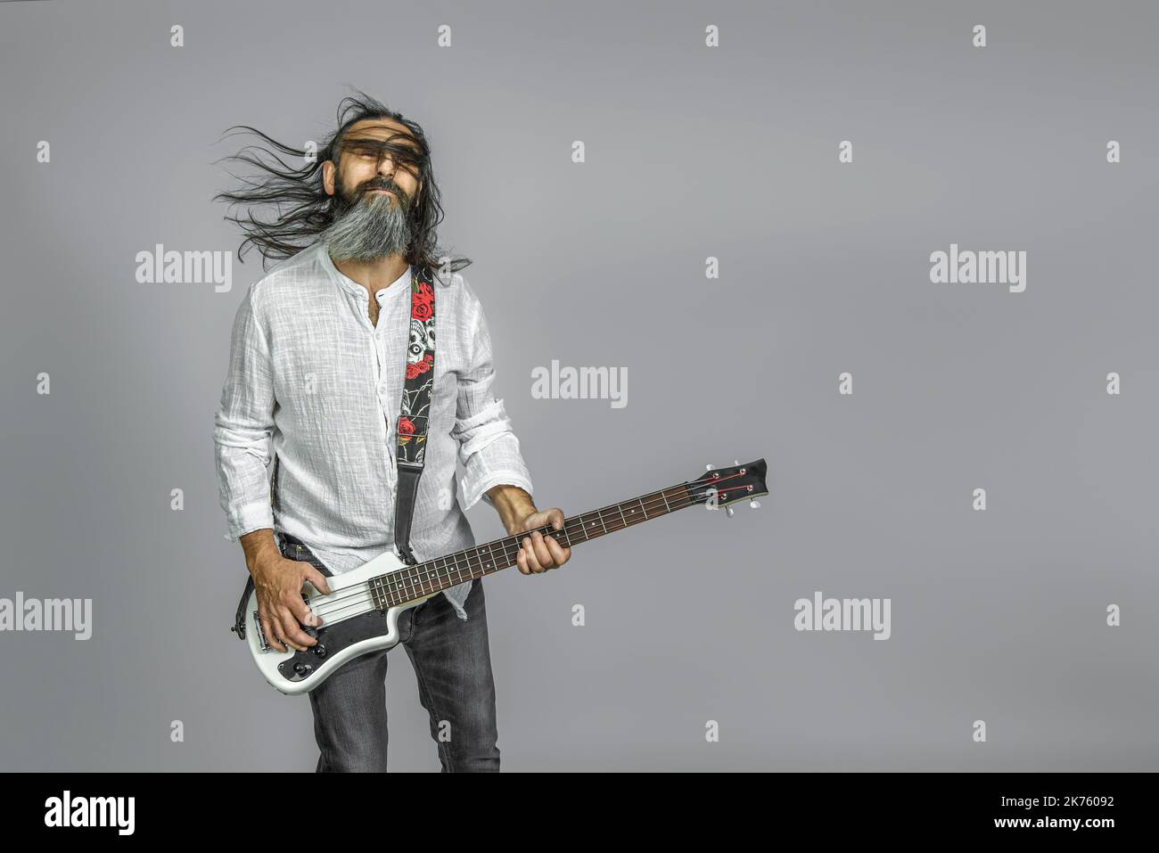 bass player with beard and long hair. studio shot Stock Photo
