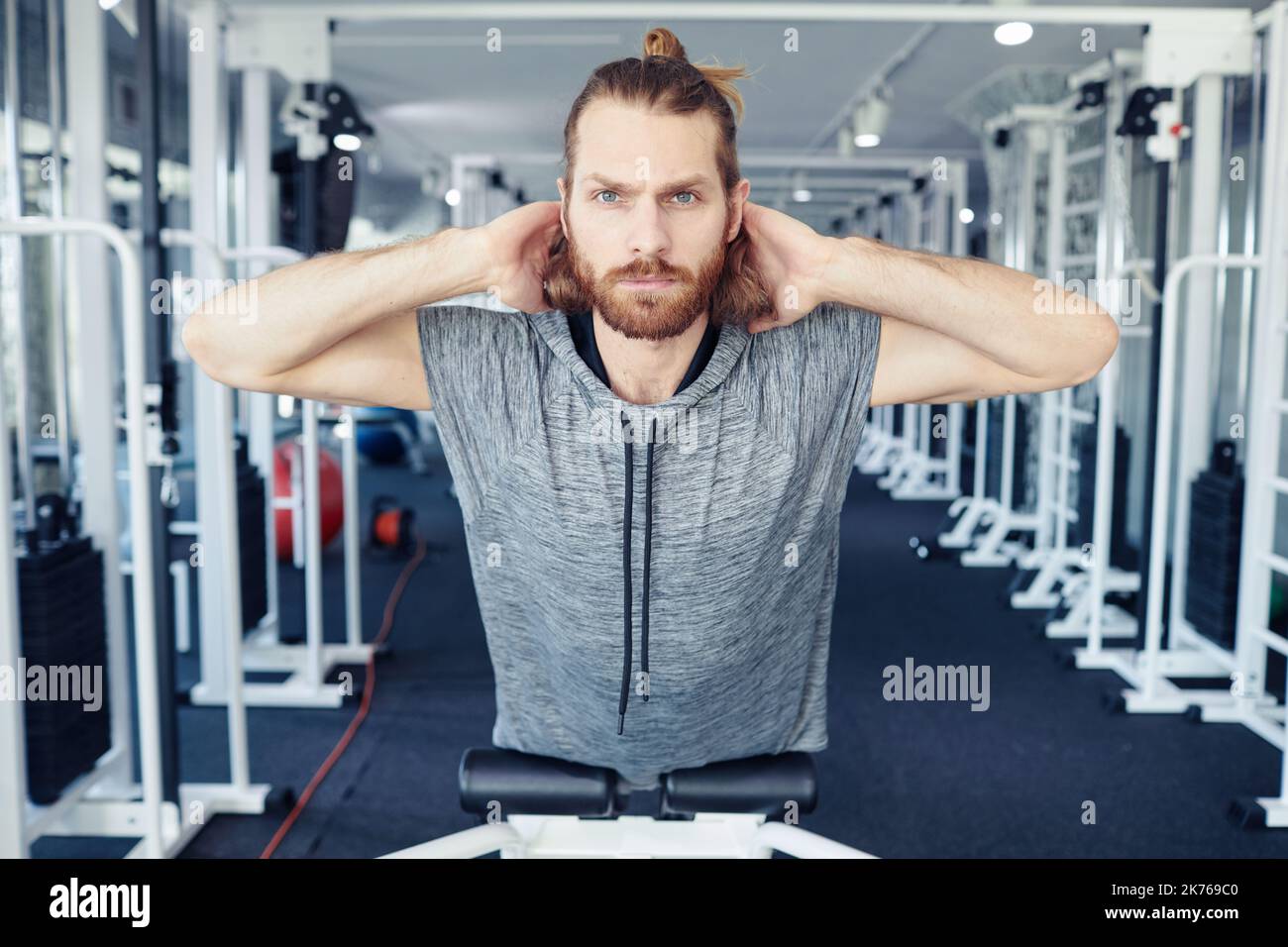 Portrait of young man doing exercises on his back in gym during his rehabilitation Stock Photo