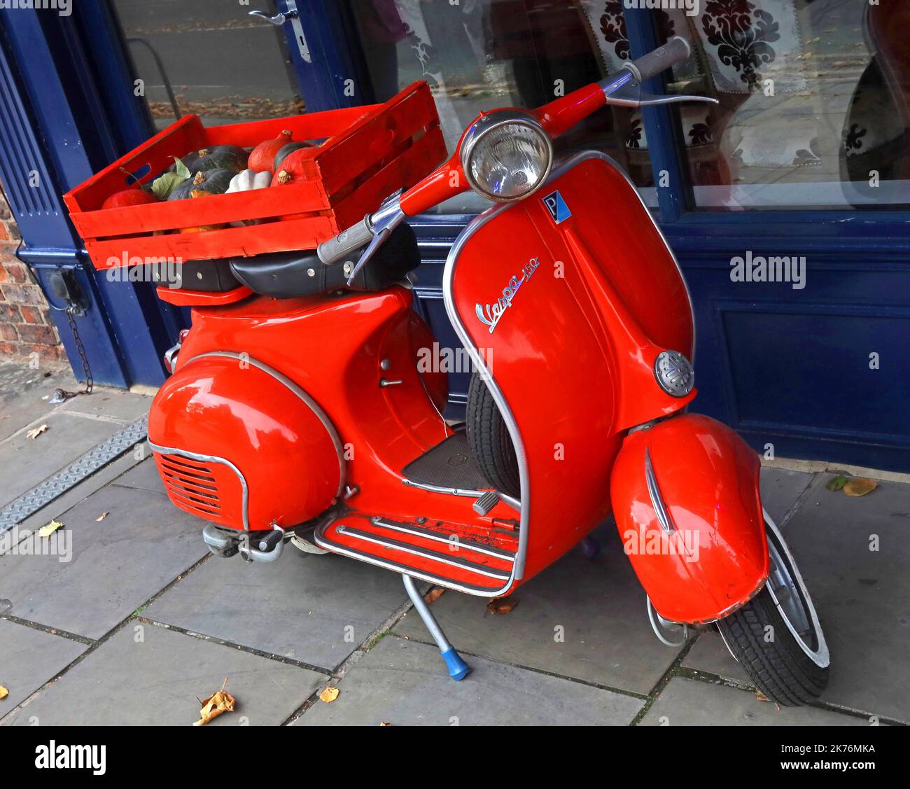 Red Piaggio Vespa 150 delivering vegetables, to a restaurant, Italy Stock Photo