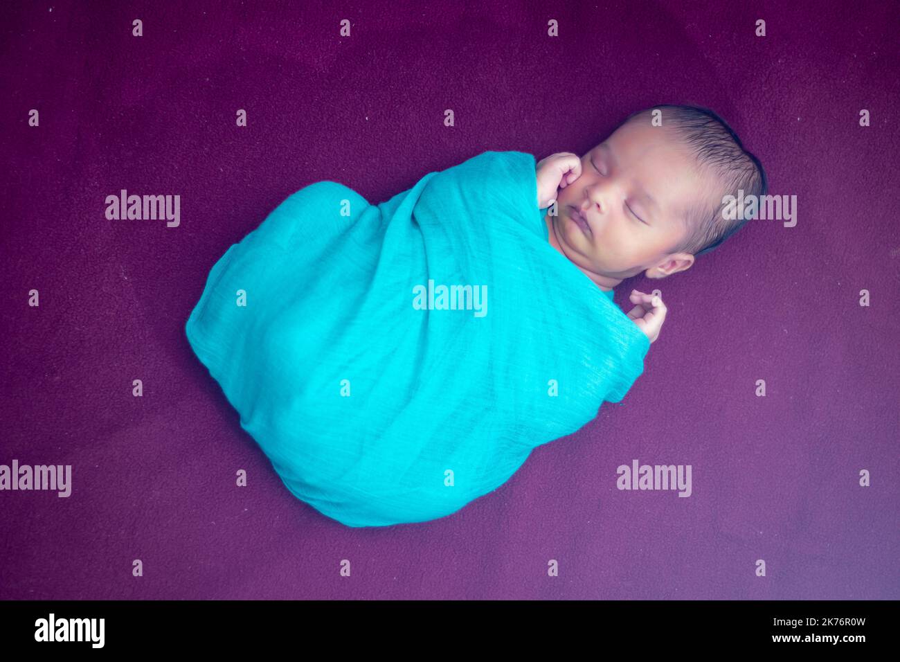 cute newborn baby sleeping in baby wrap dramatic shot Stock Photo Alamy