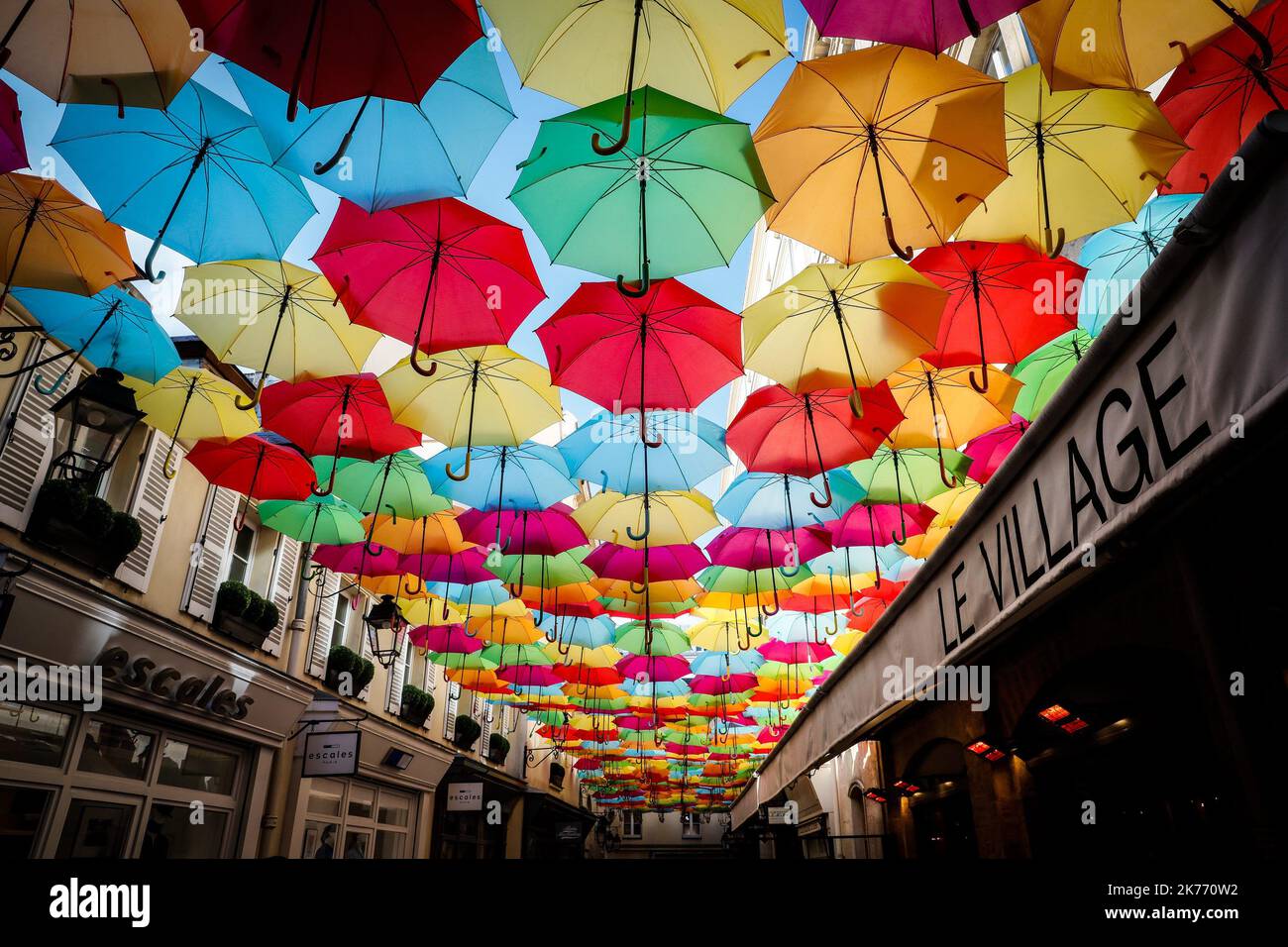 Sky of colorful umbrellas installed at Le Village Royal in Paris Stock