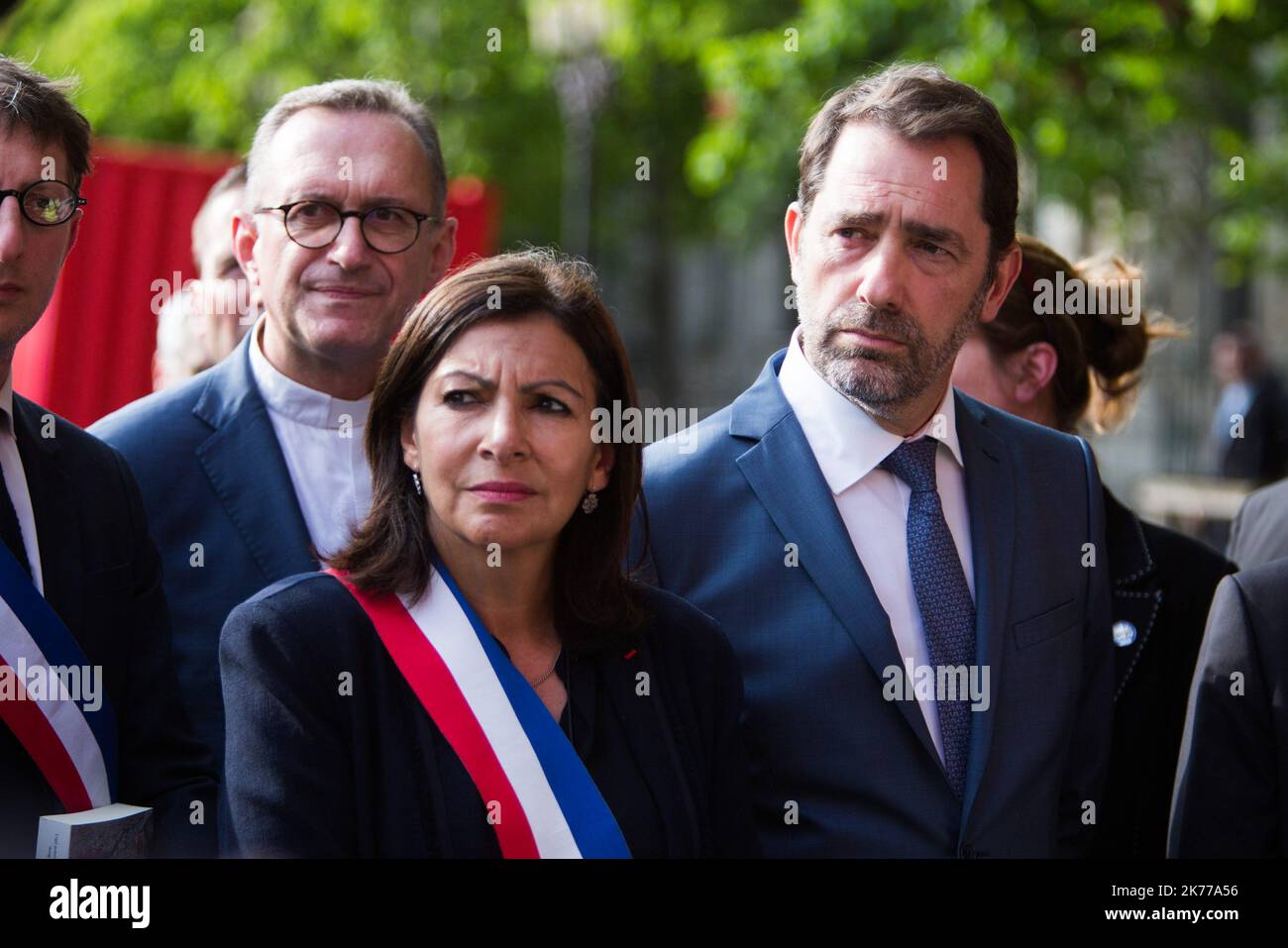 French Interior Minister Christophe Castaner, Paris prefect Didier Lallement, Paris mayor Anne Hidalgo, and other officials walk by Notre Dame cathedral on April 18, 2019 in Paris. France paid a daylong tribute on April 18, 2019 to the Paris firefighters who saved Notre Dame Cathedral from collapse, while construction workers rushed to secure an area above one of the church's famed rose-shaped windows and other vulnerable sections of the fire-damaged landmark  Stock Photo