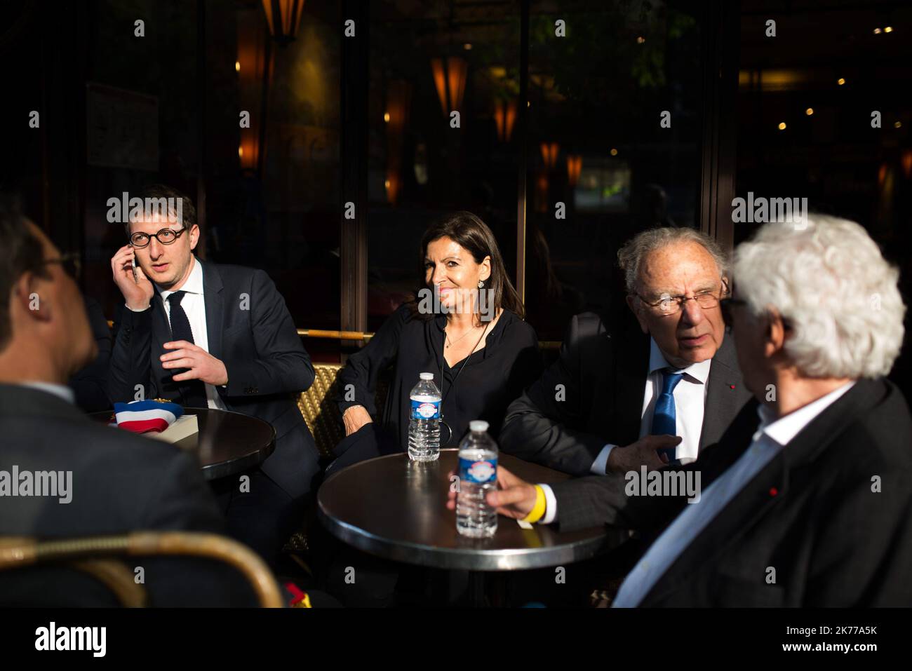 Anne Hidalgo stop to have a drink in a bar front of Notre Dame cathedral on April 18, 2019 in Paris. France paid a daylong tribute on April 18, 2019 to the Paris firefighters who saved Notre Dame Cathedral from collapse, while construction workers rushed to secure an area above one of the church's famed rose-shaped windows and other vulnerable sections of the fire-damaged landmark.  Stock Photo