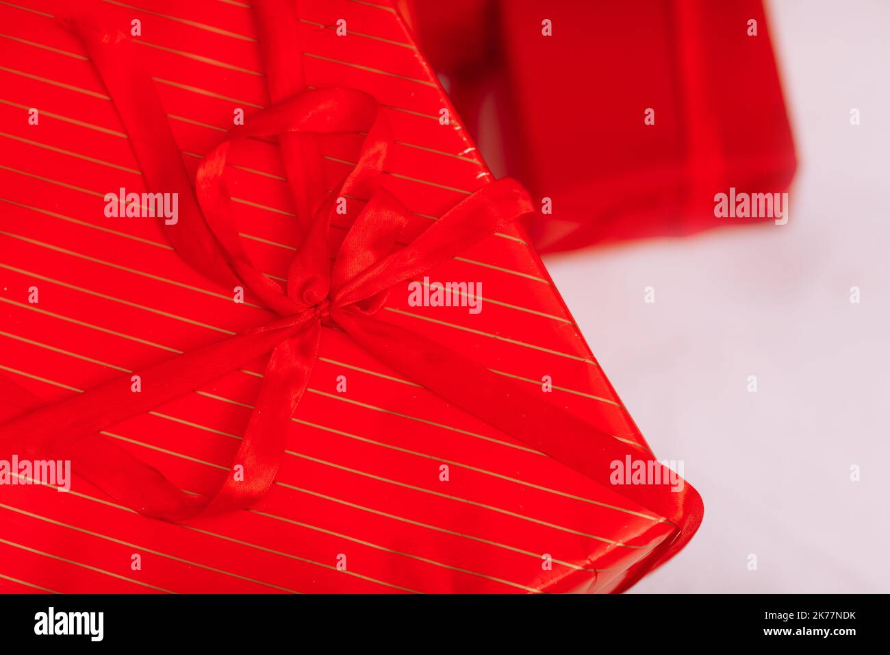 Red gift boxes with ribbons and Christmas baubles on white background ...