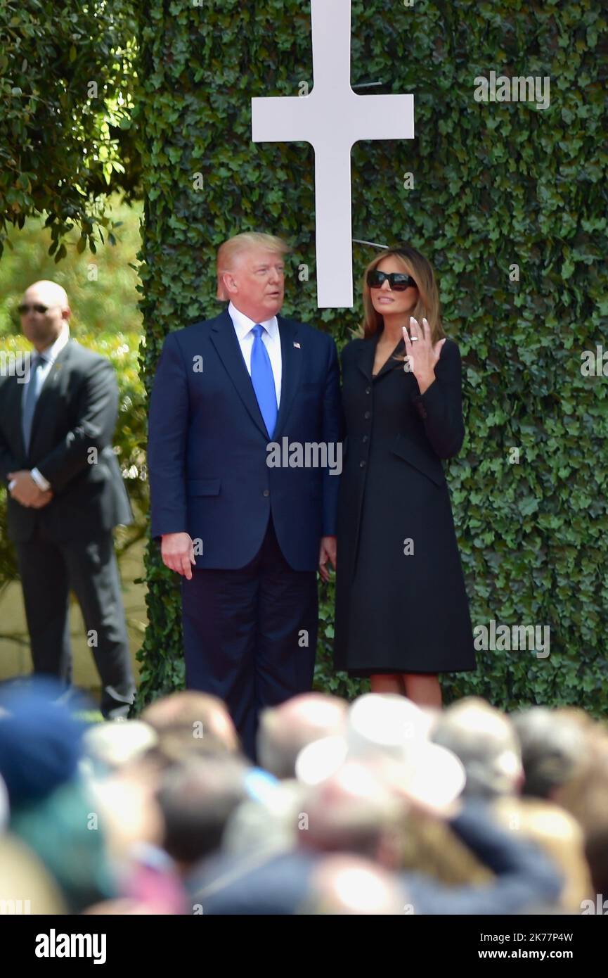 U.S. President Donald Trump and First Lady Melania Trump during their state visit to see French President Emmanuel Macron and French First Lady Brigitte Macron during a ceremony to commemorate the 75th anniversary of D-Day at the Normandy American Cemetery and Memorial in Colleville-sur-Mer, France, on Thursday, June 6, 2019. Stock Photo