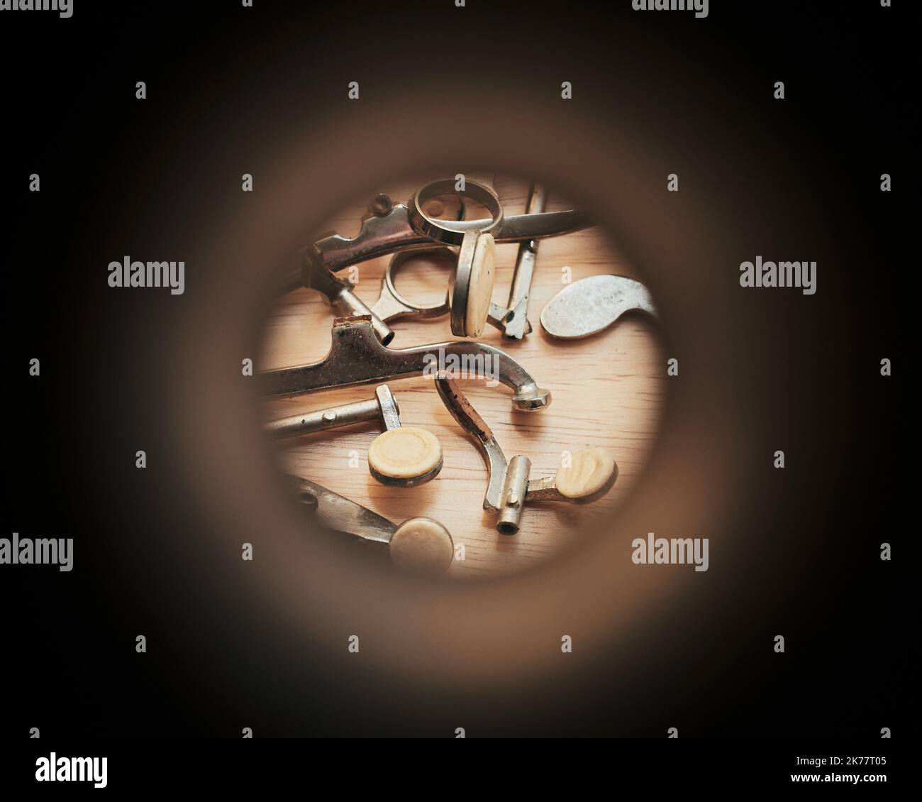 Various old keys and pads are seen through the aperture of a