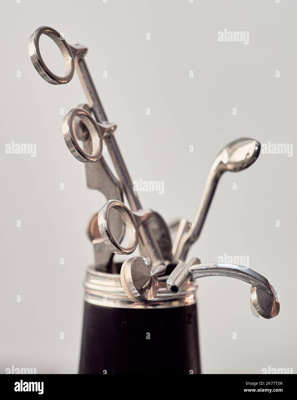 spare keys and other parts are arranged as a metal bouquette inside a bell