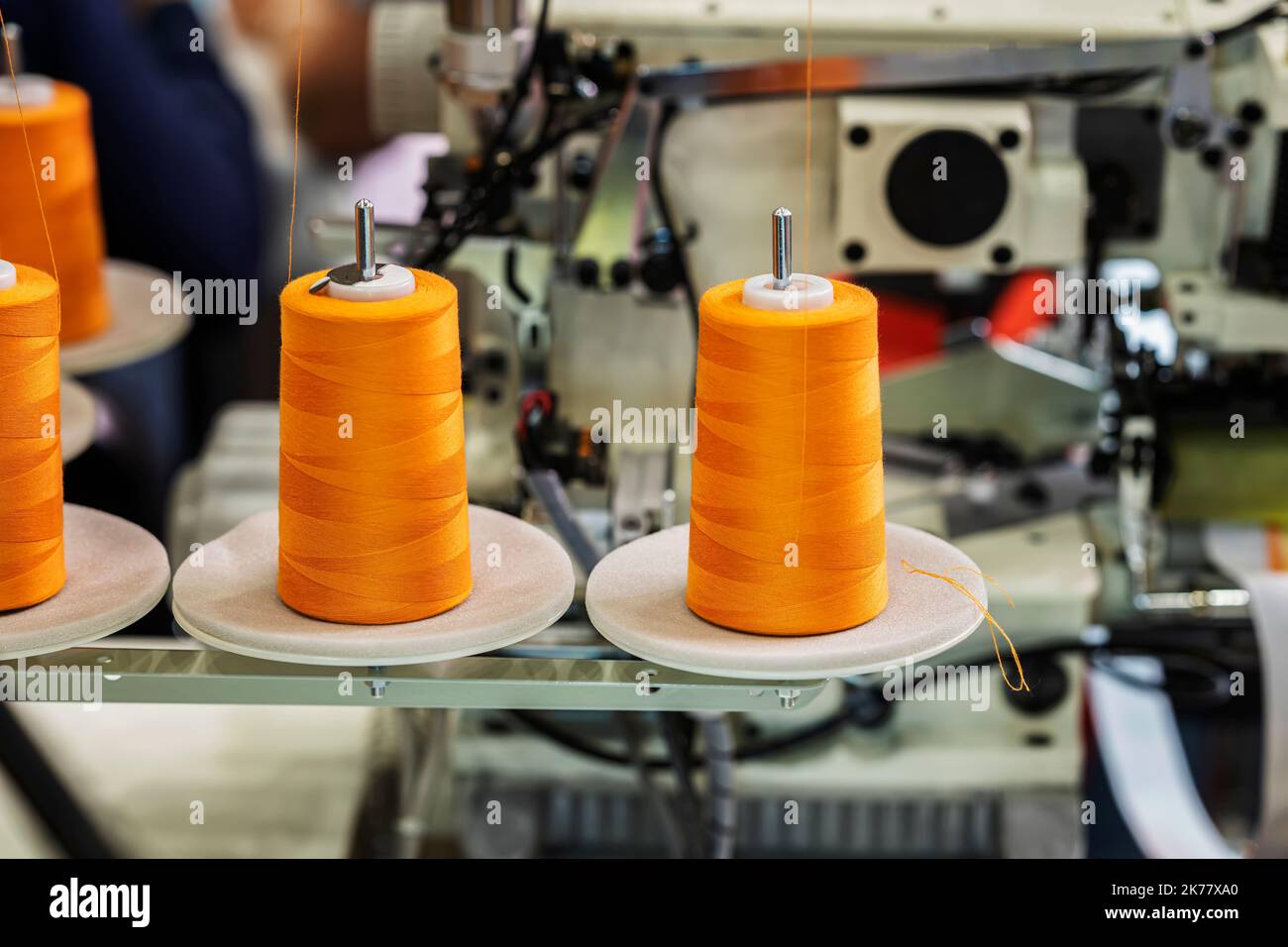 Spools with orange threads on sewing machine. Sewing Equipment, Textile Industry Stock Photo Alamy
