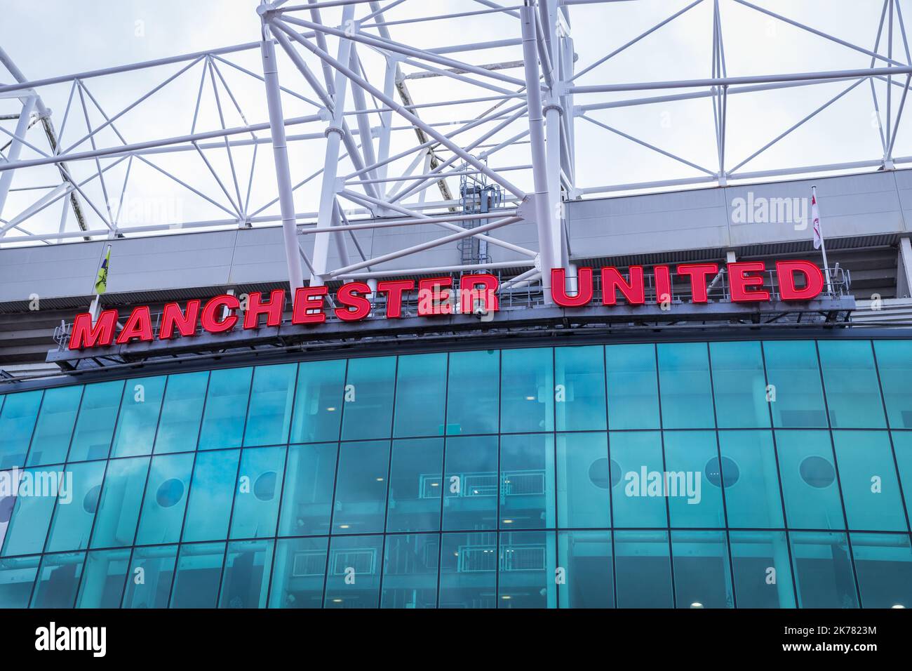 Facade of Old Trafford stadium with Manchester United's name Stock Photo