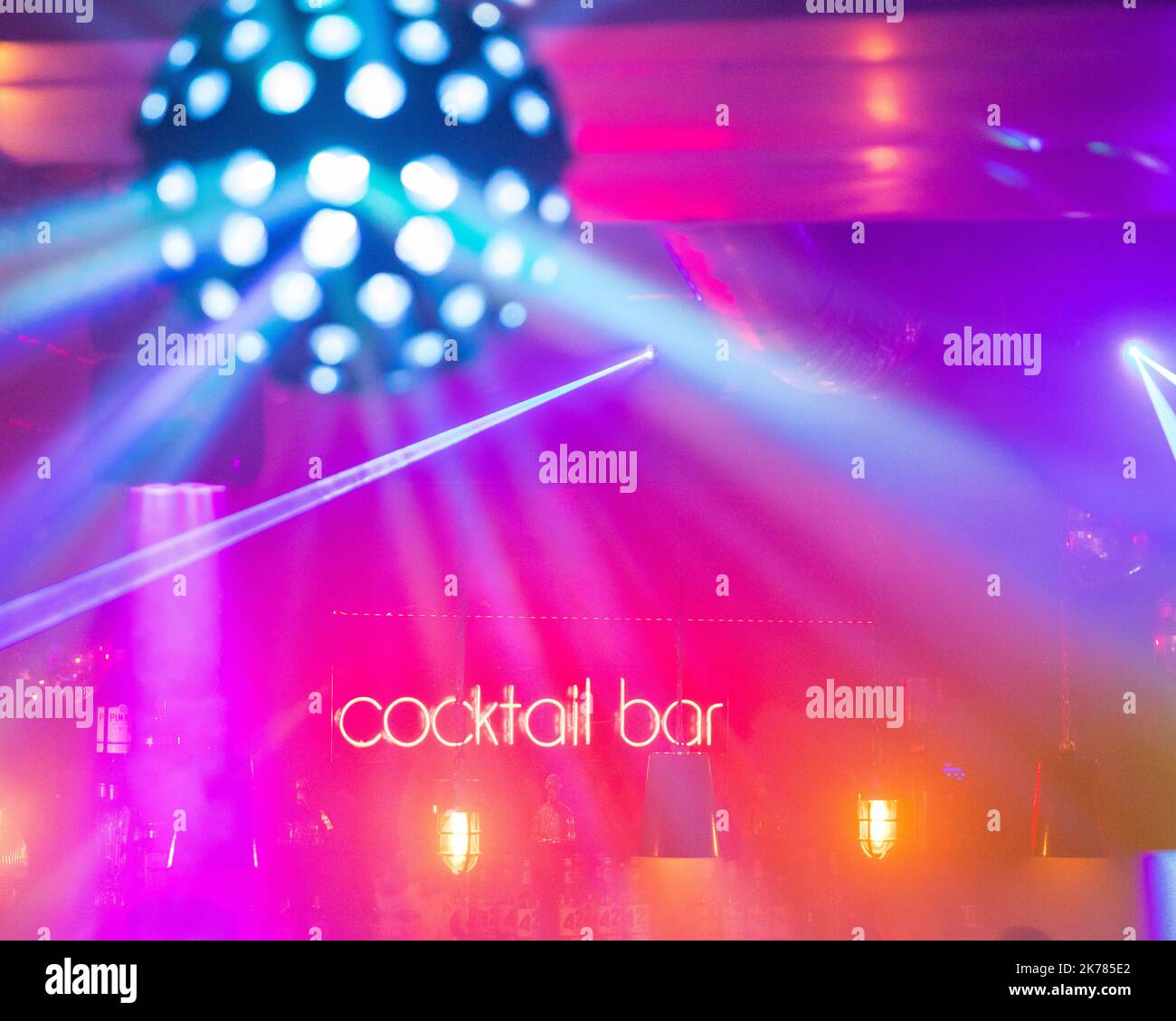 Glitter ball with neon sign saying cocktail bar Stock Photo Alamy