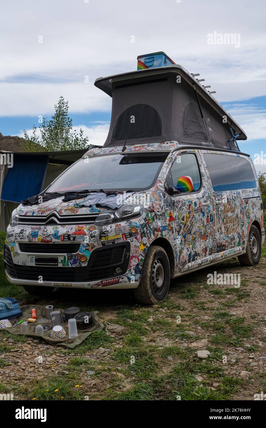 close-up of Citroen camper van dormer motor home covered all over in company logo stickers set up at camp Stock Photo