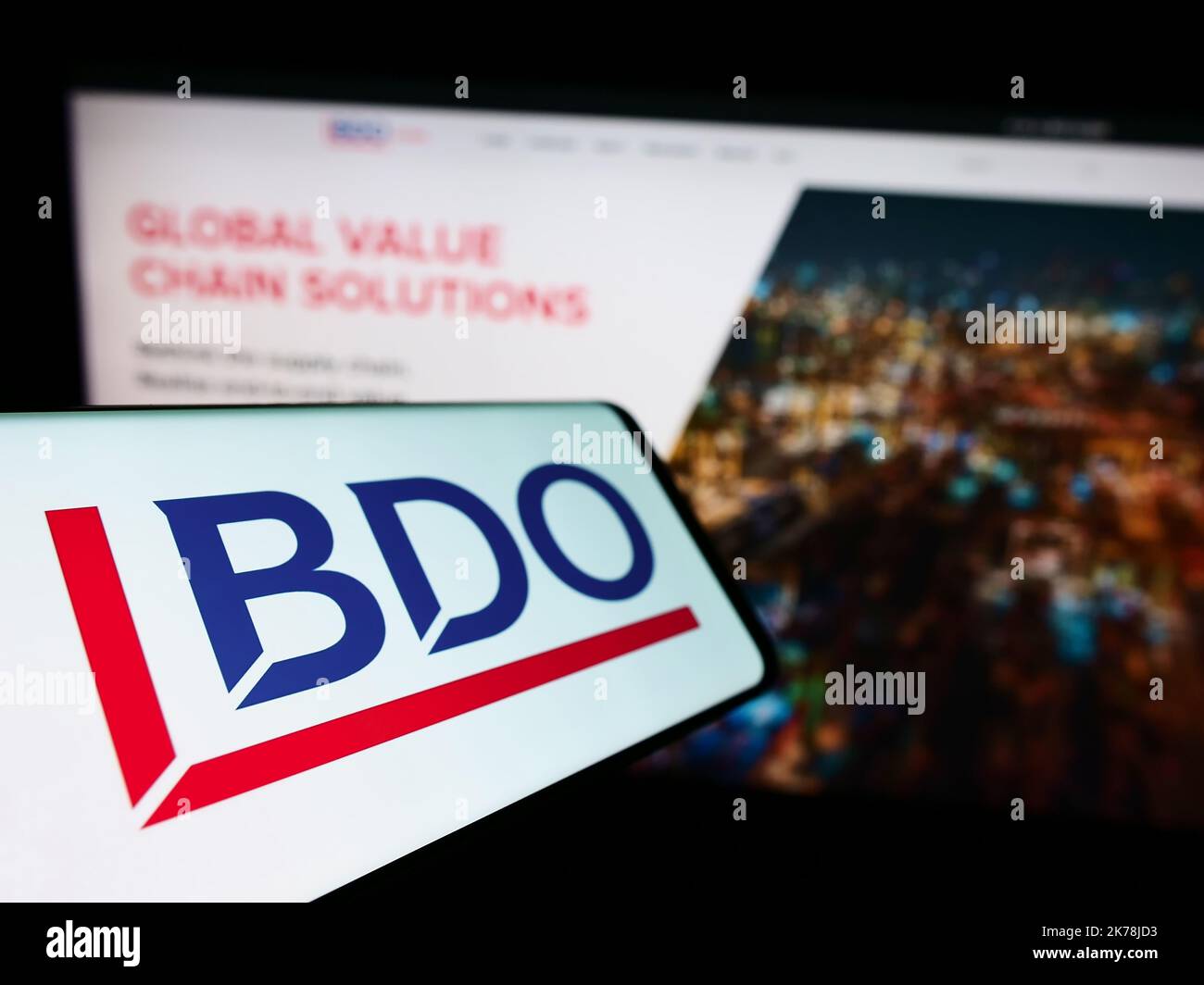 Smartphone with logo of accounting network BDO Global on screen in front of business website. Focus on left of phone display. Stock Photo