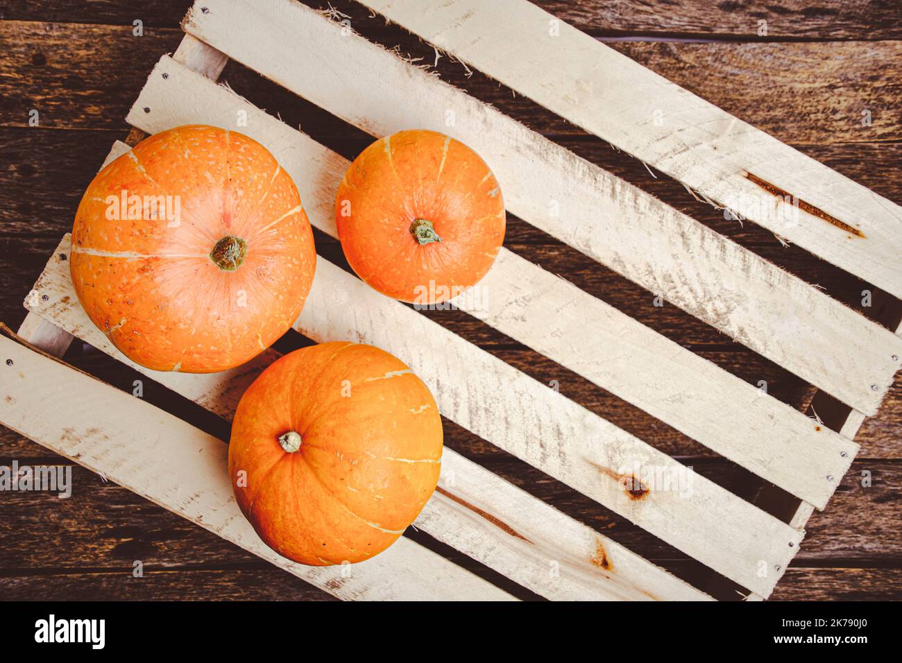 Pumpkins wooden background lie on vegetable box Stock Photo - Alamy