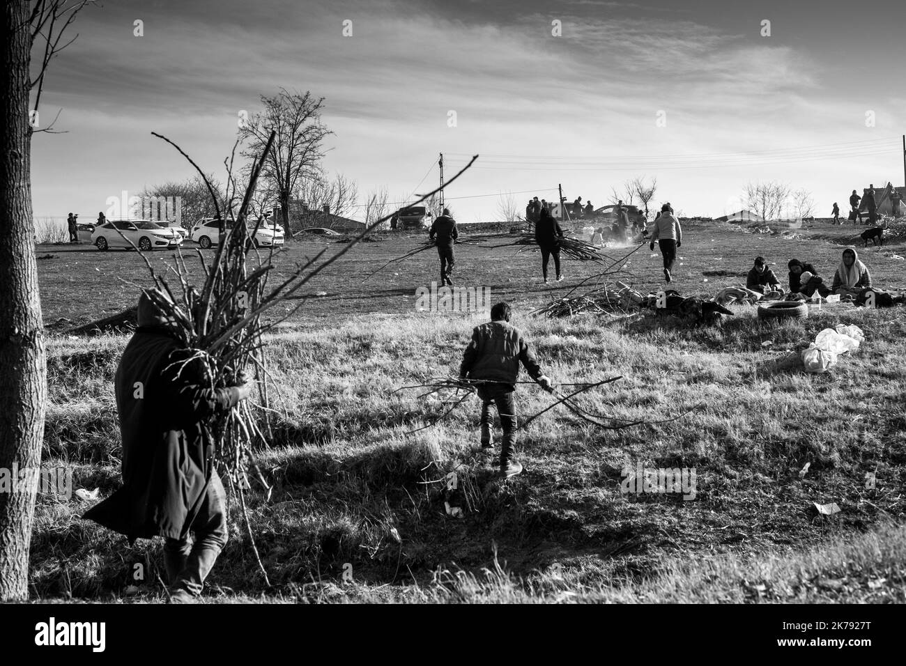 Refugees carry wood which they will use to heat themselves for the night. Three days ago after President Erdogan's announcement to open the borders, thousands of refugees gathered in the Edirne region in the hope of rallying Greece. March 2, 2020. Doyran, Turkey. Stock Photo