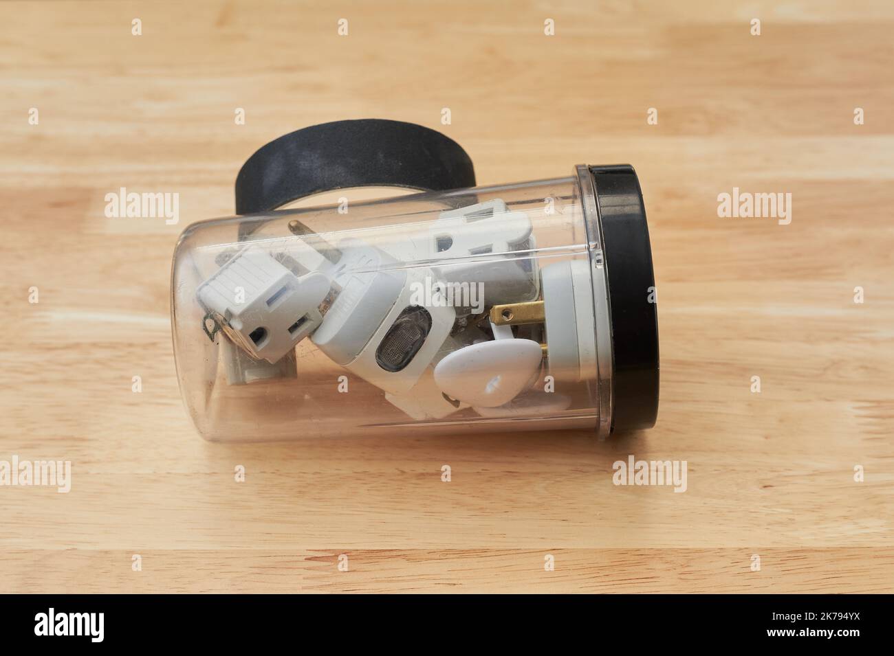 Electrical tape, grounding plugs and circuit interrupters are lying on