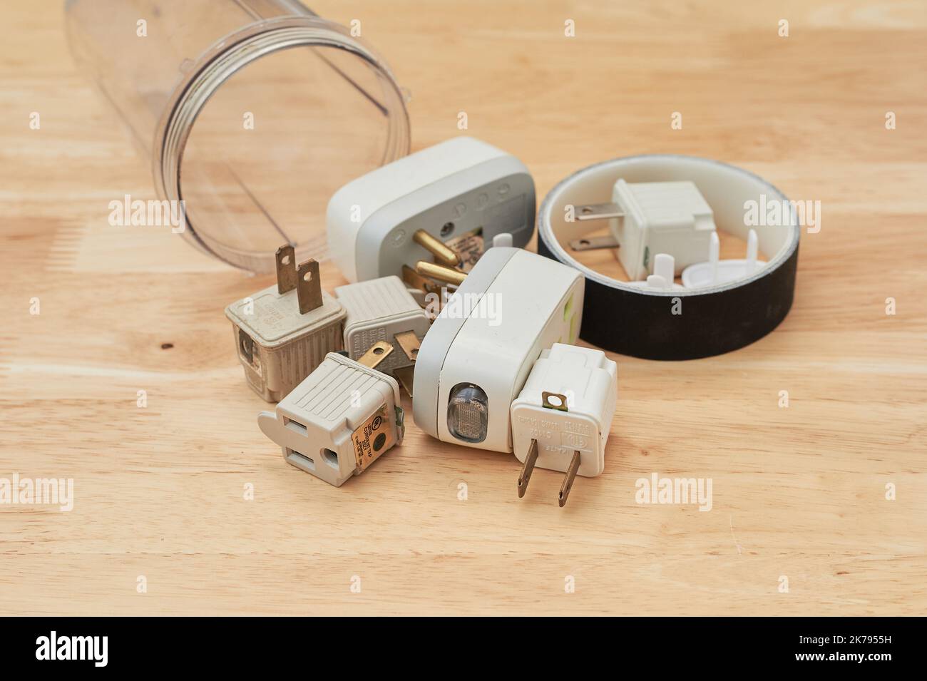 Electrical tape, grounding plugs and circuit interrupters are lying on