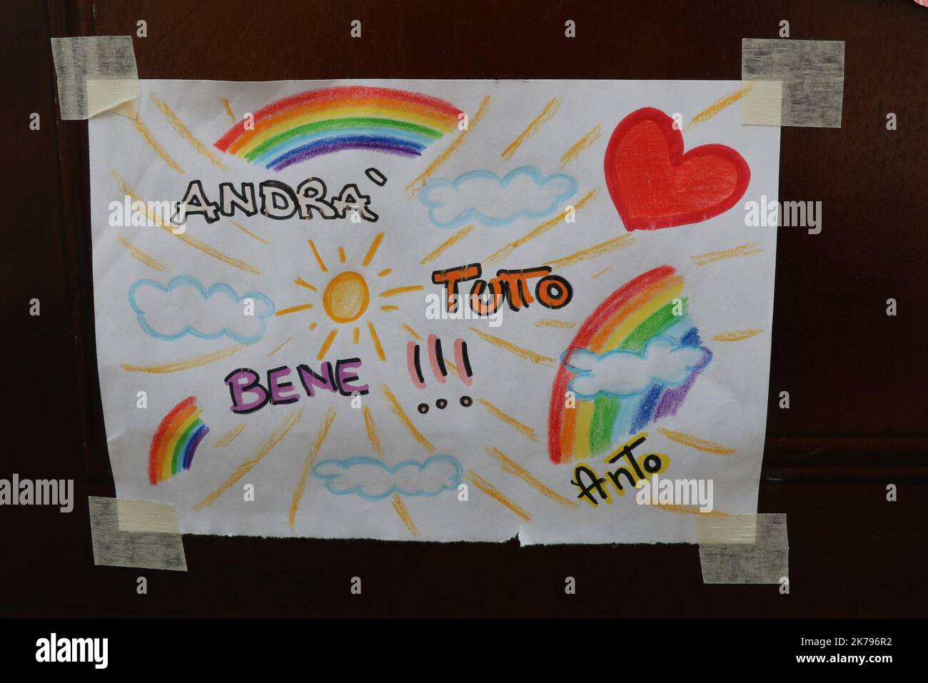 Pergine Valsugana, Italy. Most part of Europe is today on a sweeping confinement to try to slow down the spread of the Covid-19 Pandemic.  Andra Tutto Bene - Tout Ira Bien, Hope message with a rainbow   Stock Photo