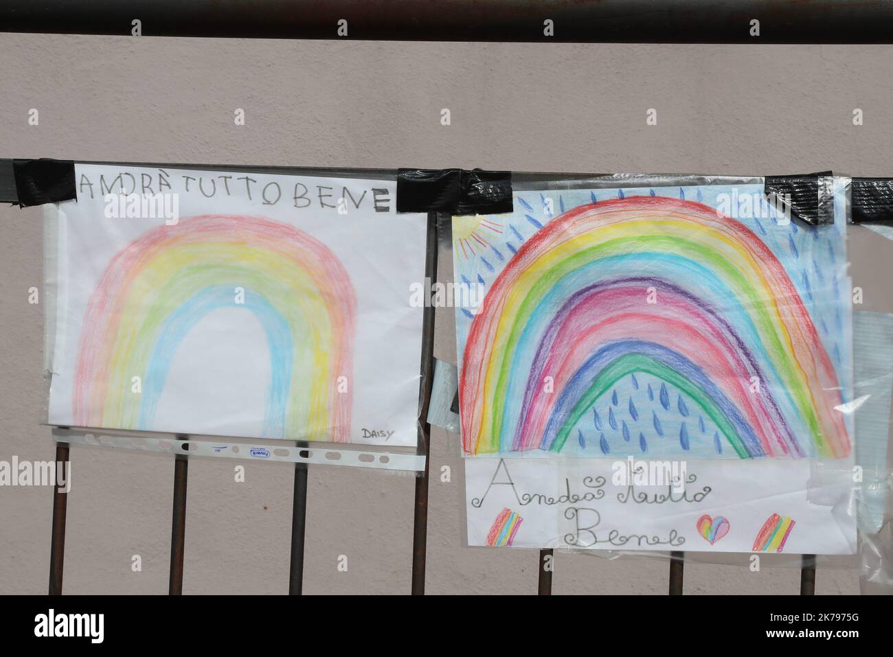Most part of Europe is today on a sweeping confinement to try to slow down the spread of the Covid-19 Pandemic. Hope Message  'Andrà tutto bene' Everything Will Go Fine and Rainbow drawings made by children  Stock Photo