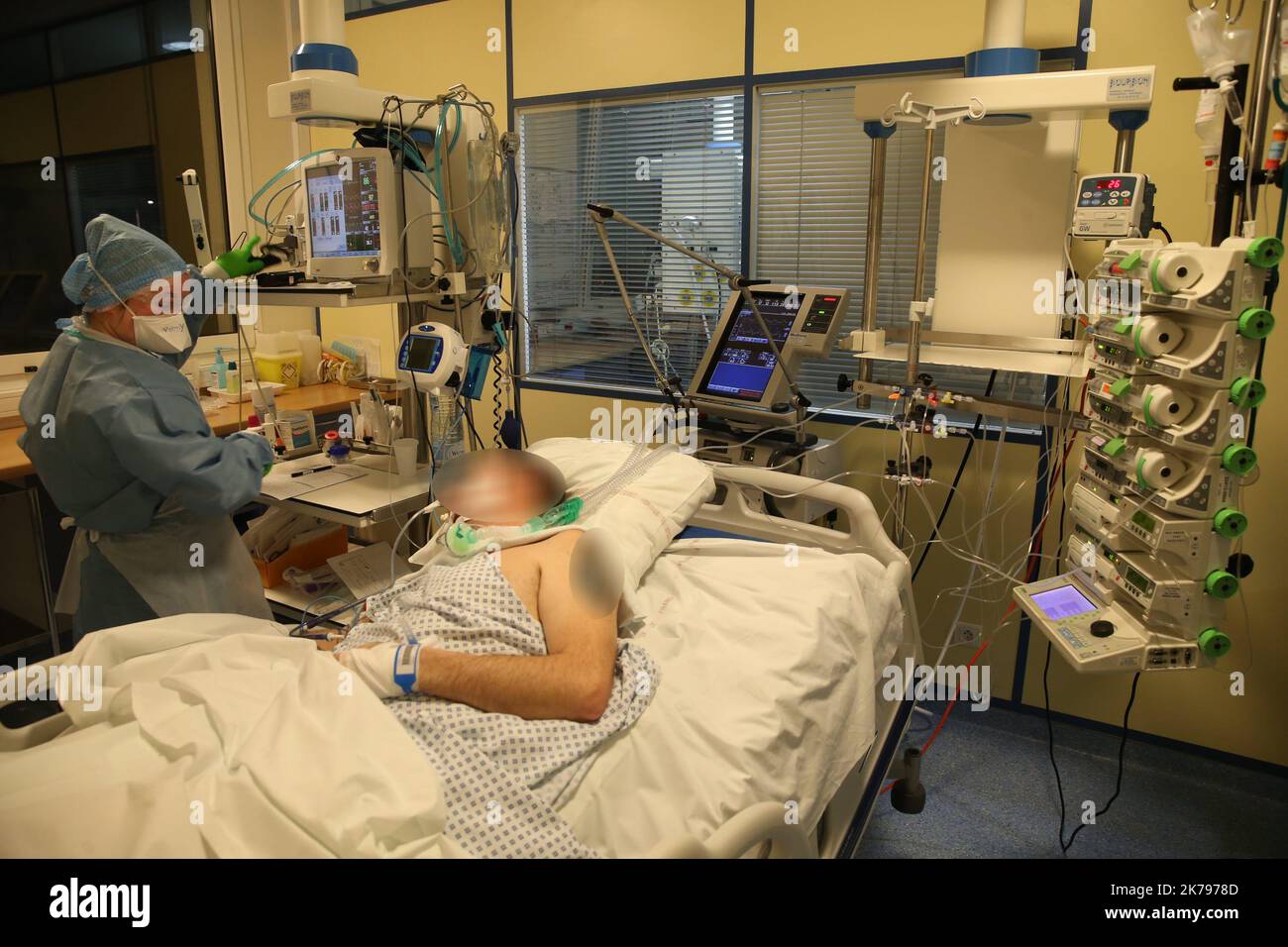 A nurse monitors the equipment. All patients with covid-19 are intubated and sometimes placed in the prone position to improve their ventilation. Stock Photo