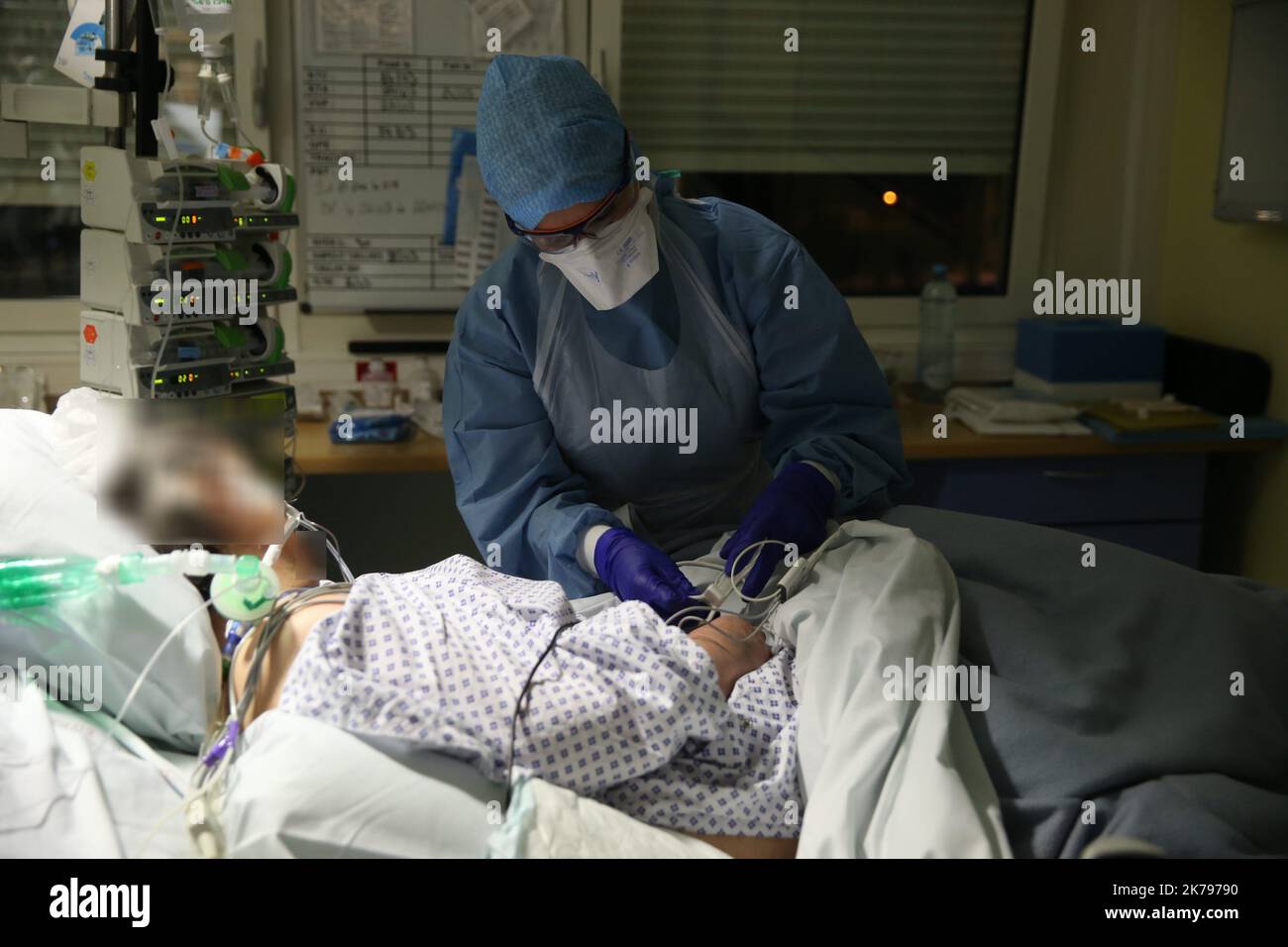 A nurse monitors the equipment. All patients with covid-19 are intubated and sometimes placed in the prone position to improve their ventilation. Stock Photo