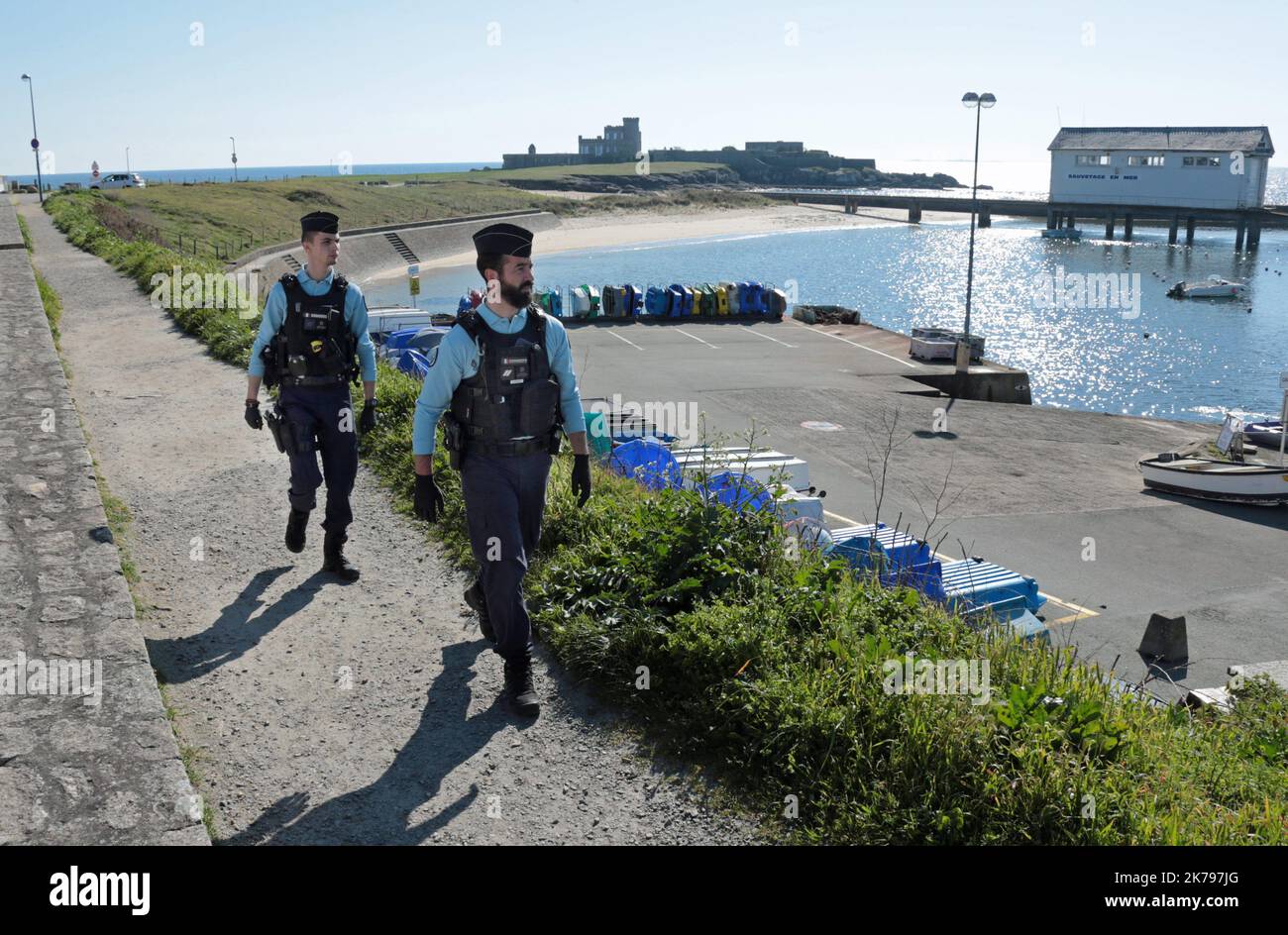 Police patrol the coastal path in Nevez, France as they make sure members of the public are observing the lockdown Stock Photo