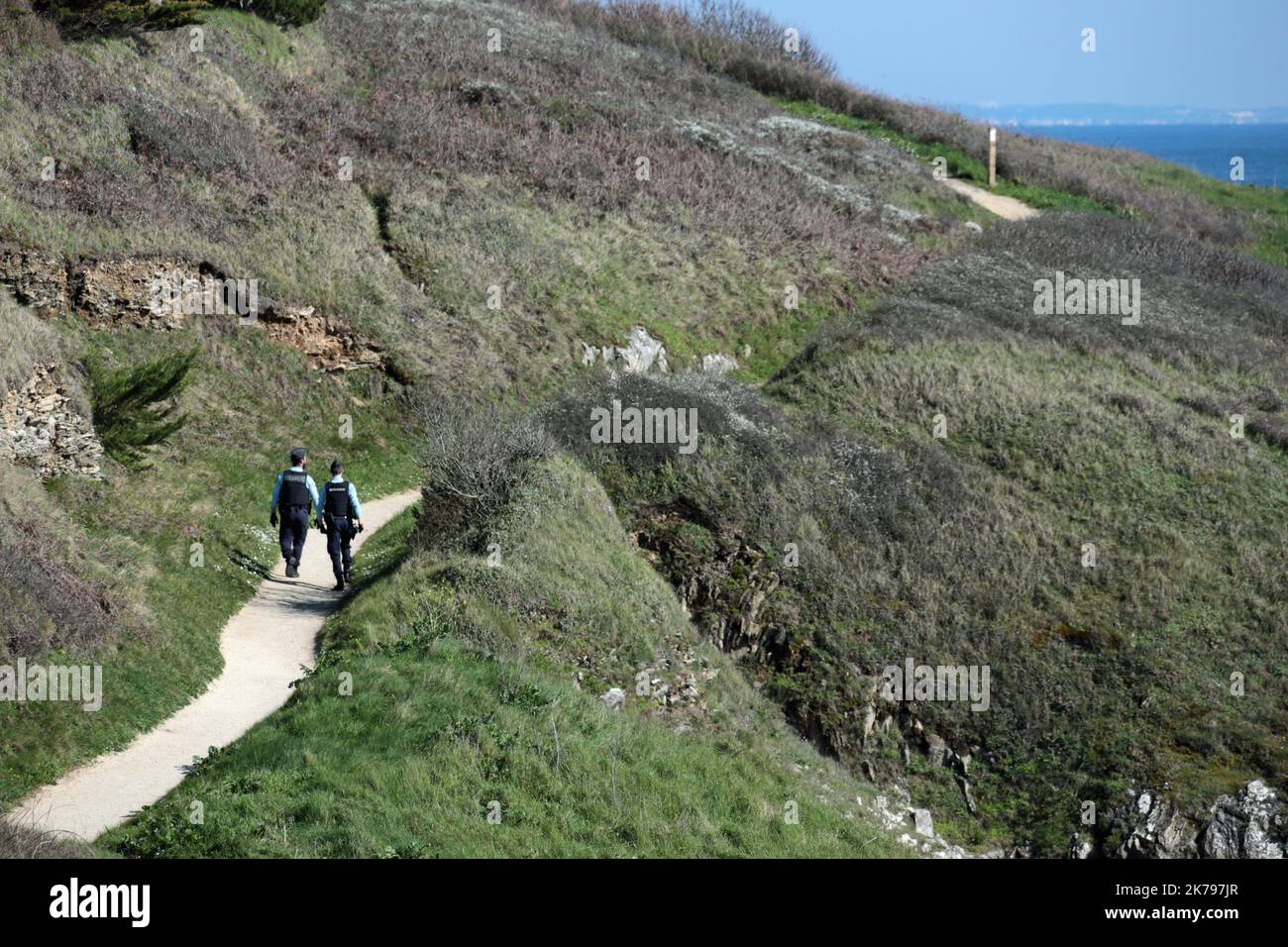 Police patrol the coastal path in Nevez, France as they make sure members of the public are observing the lockdown Stock Photo