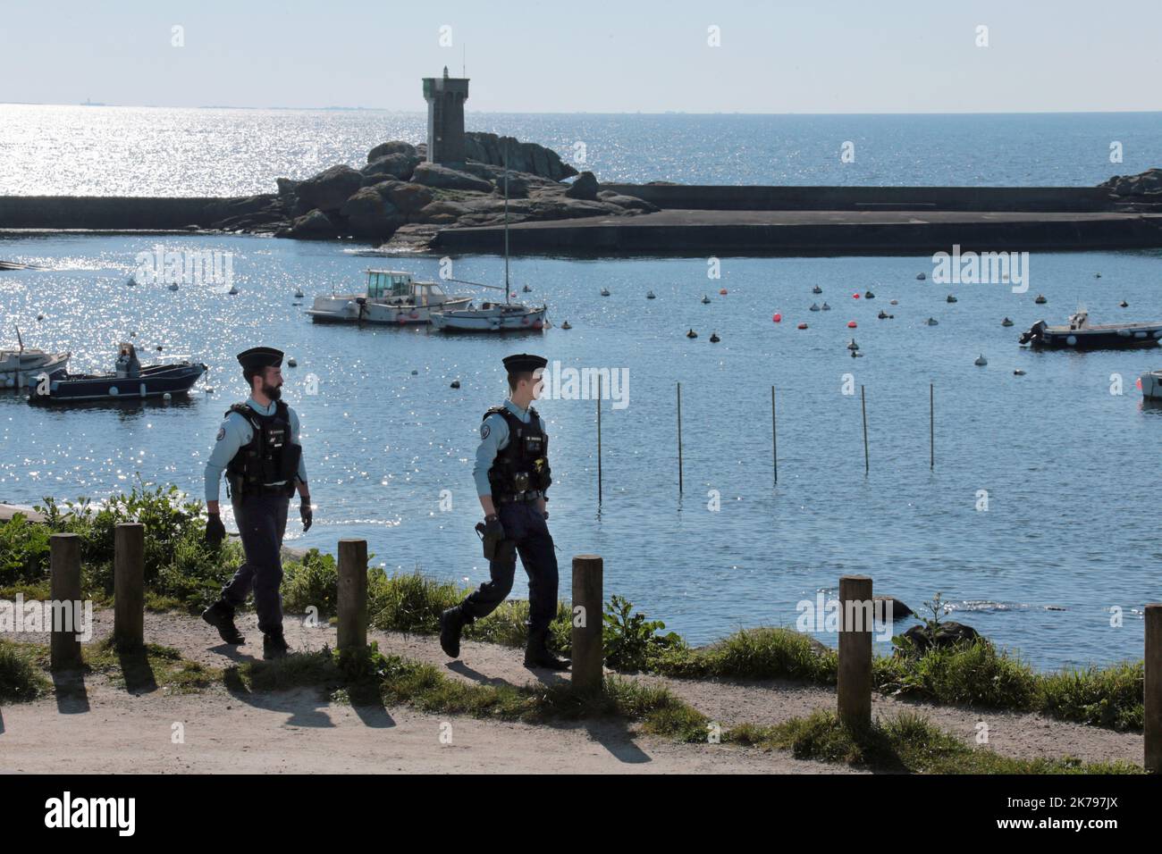 Police patrol the coastal path in Nevez, France as they make sure members of the public are observing the lockdown Stock Photo