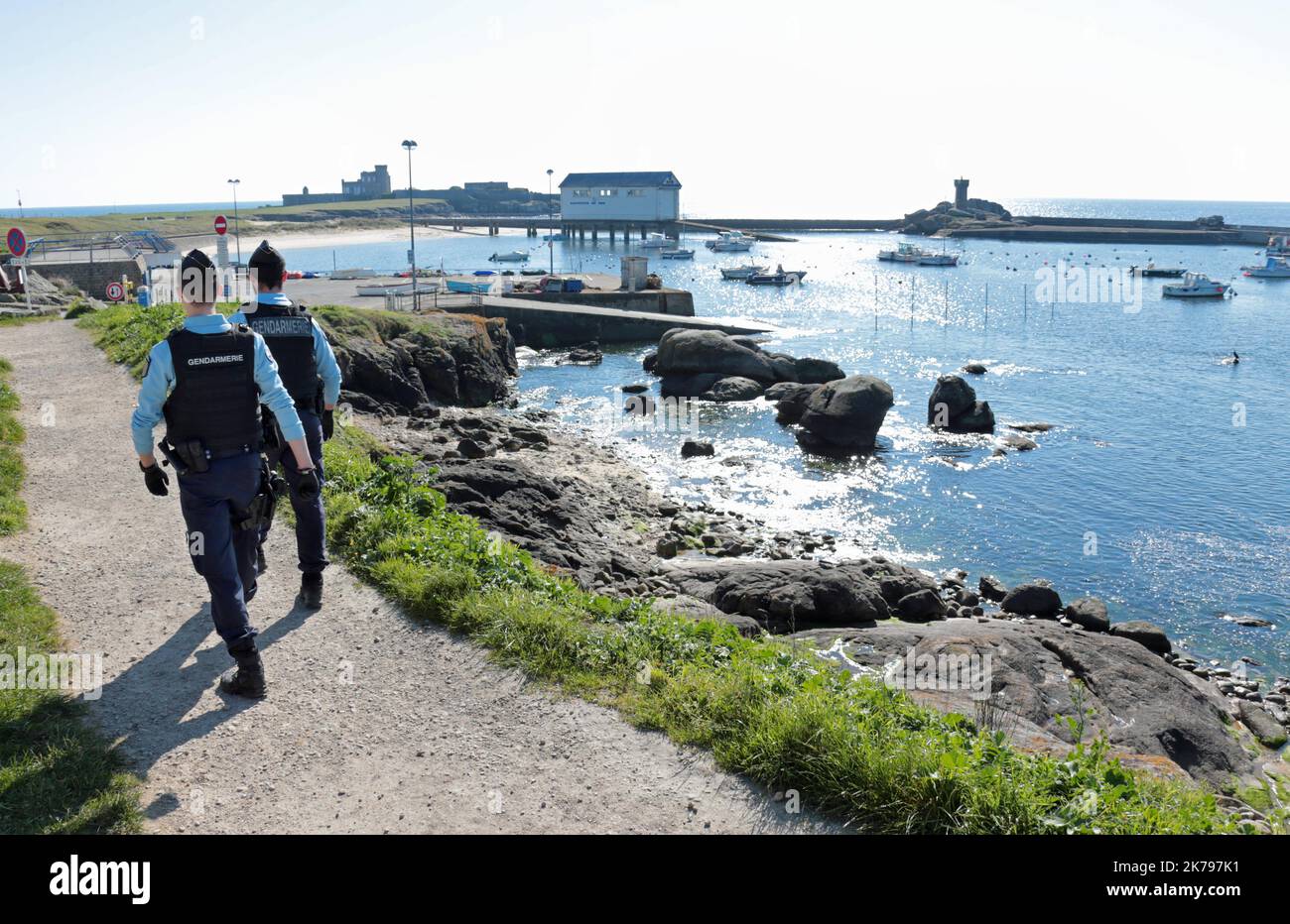 Police patrol the coastal path in Nevez, France as they make sure members of the public are observing the lockdown Stock Photo