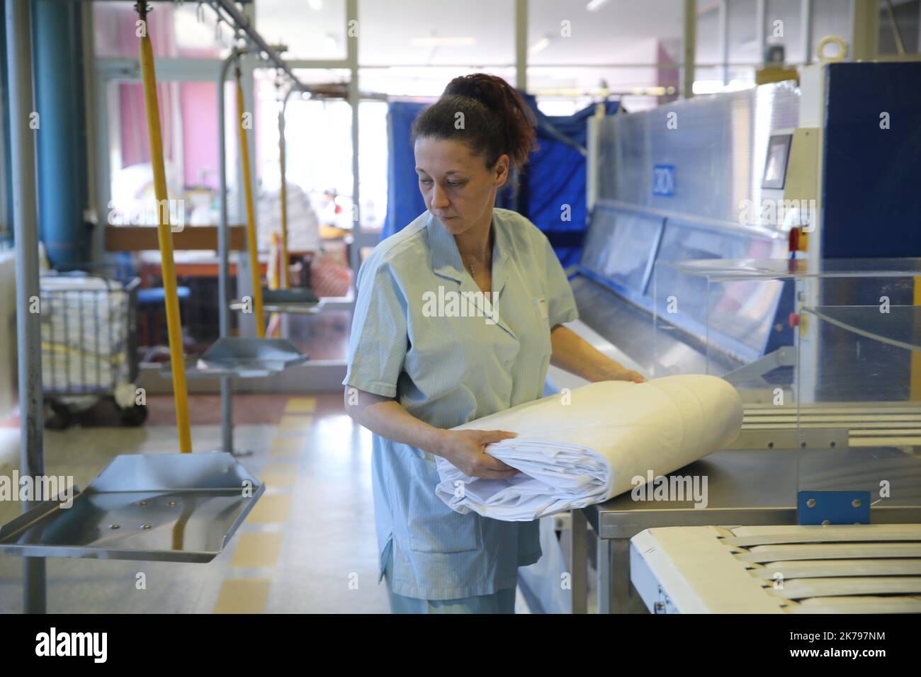 Employees processing linen at the laundry at the Emile Muller hospital