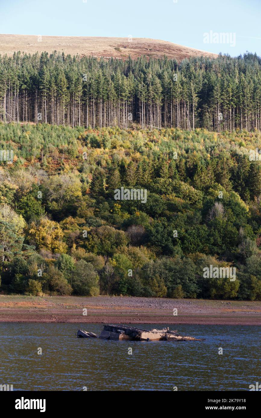 Talybont reservoir, South Wales, UK.  17 October '22.  UK weather: A sunny afternoon at the reservoir.  Water levels still low following the summer heatwave.  A structure still visible that was in use before the reservoir was built.  Credit: Andrew Bartlett/Alamy Live News. Stock Photo
