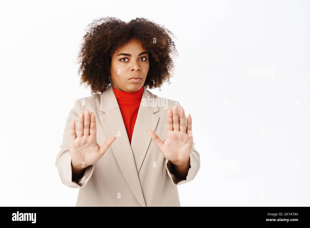 Corporate people. Serious african american woman shows stop, prohibit ...