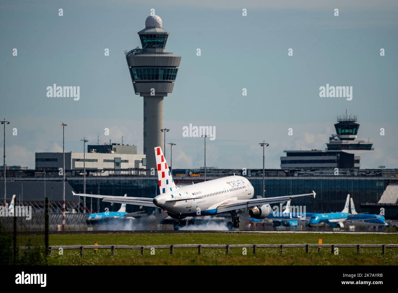 Amsterdam Schiphol Airport, AMS, aircraft approaching Kaagbaan, runway, terminal building, air traffic control tower, 9A-CTH, Croatia Airlines Airbus Stock Photo