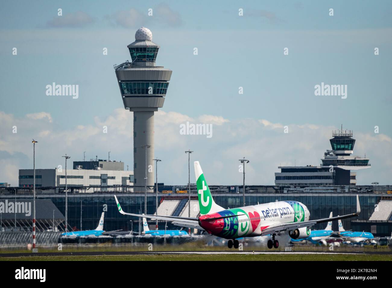 Amsterdam Schiphol Airport, AMS, aircraft approaching Kaagbaan, runway, terminal building, air traffic control tower, PH-HSI Transavia Boeing 737-800, Stock Photo