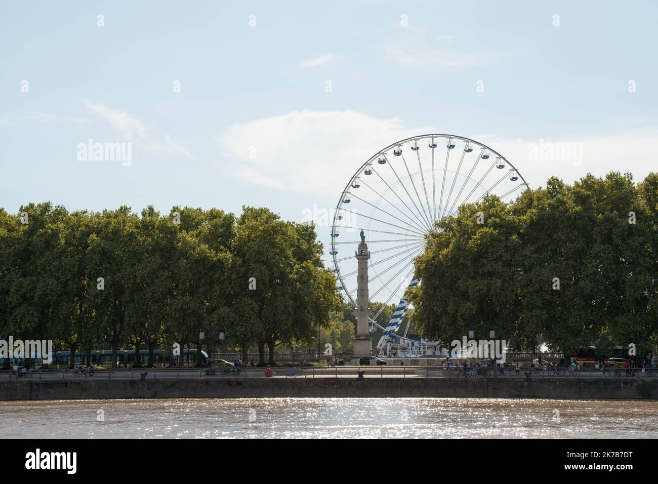 Bordeaux, France; 08092022: Fair ferris wheel at Bordeaux park. Water front seen from a boat. Stock Photo