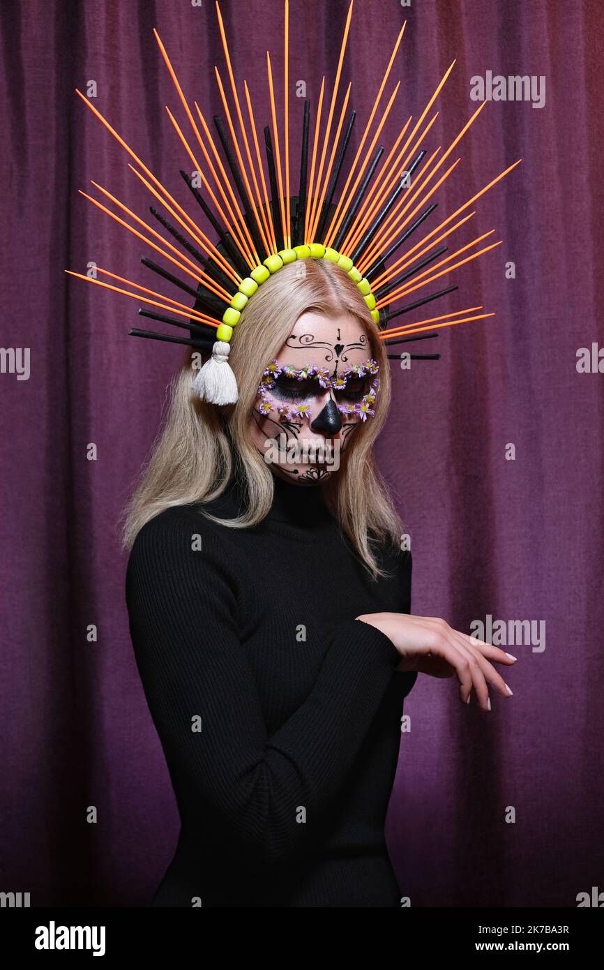 Halloween Make-Up Style, Fancy Dress and Diadem. Blond Model Wear Sugar Skull Makeup with Crown. Santa Muerte concept Stock Photo