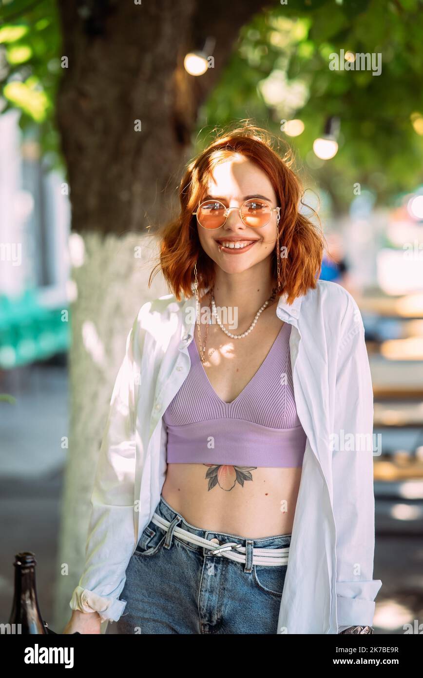 Young woman with toothy smile in outdoors Stock Photo - Alamy