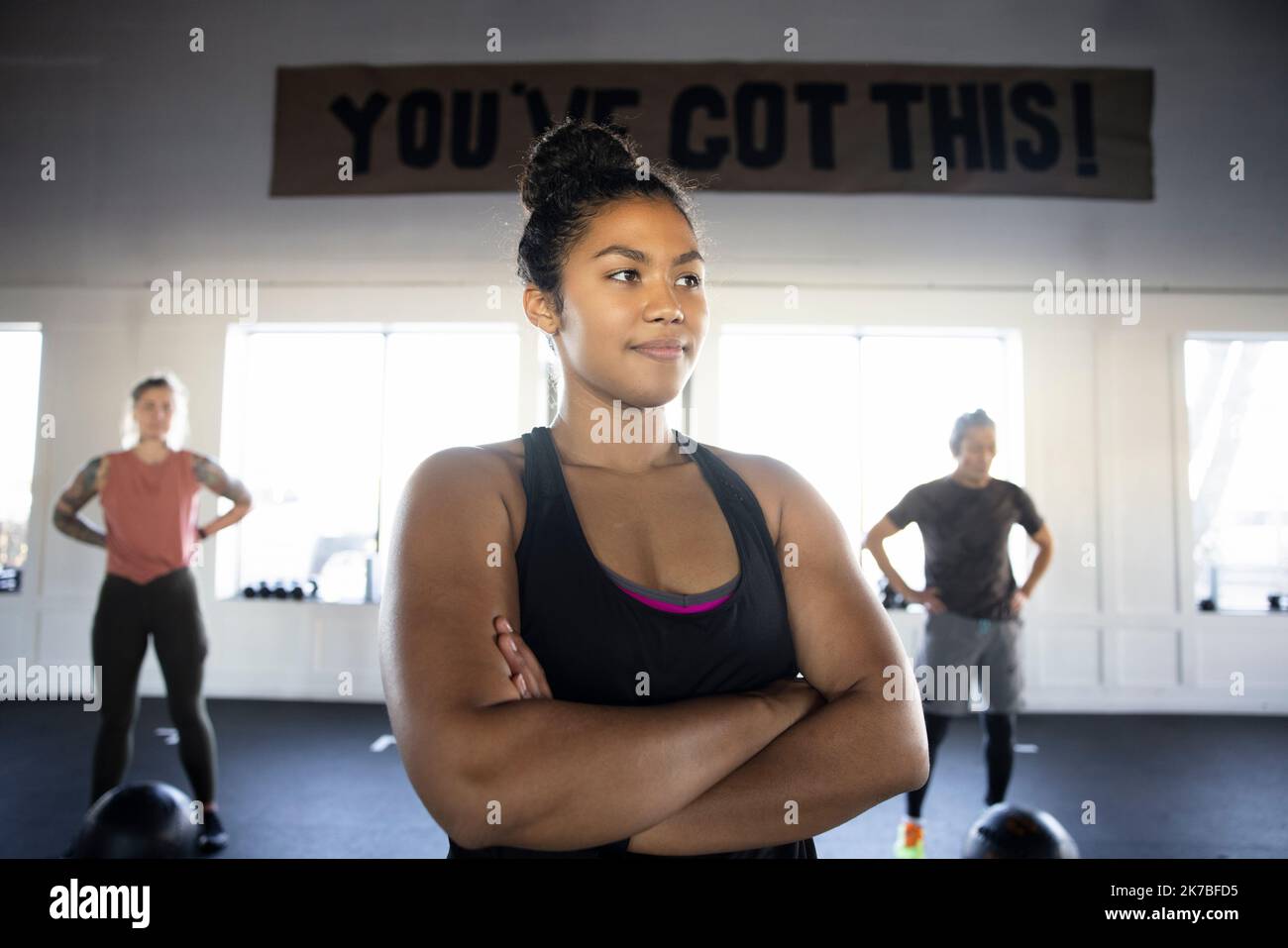 Portrait confident determined young woman in group fitness class Stock Photo