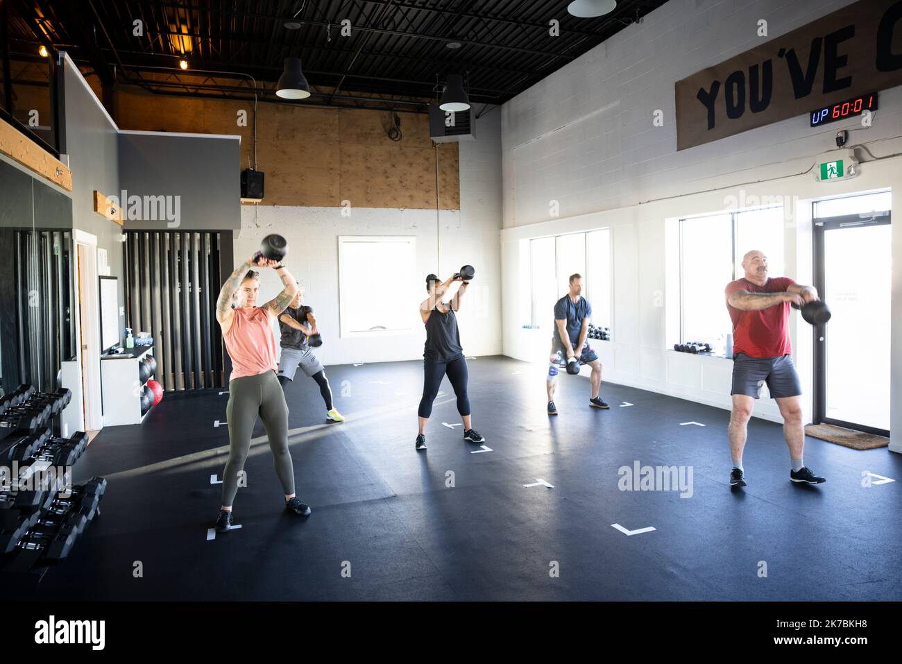 Group fitness class doing kettlebell swings in gym studio Stock Photo Alamy