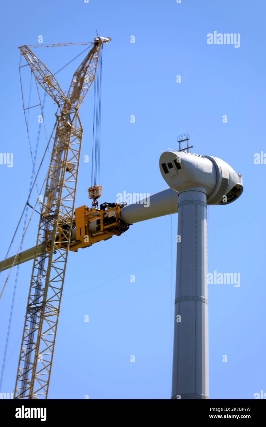 Constructing wind-turbines by using a large crane Stock Photo