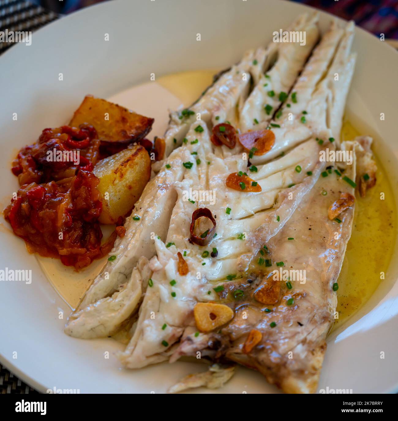 Eating in restaurant of fresh grilled with garlic and olive oil on old