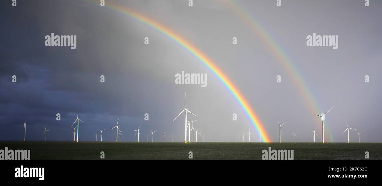Wind-turbines and a rainbow in the Ijsselmeer, Holland Stock Photo