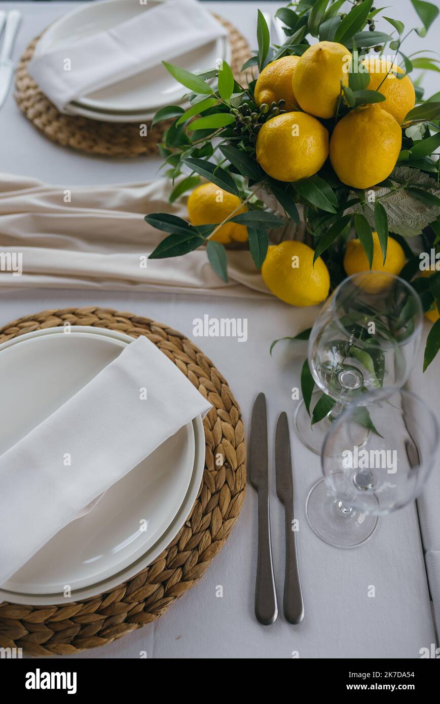 Festive table at the wedding party decorated with lemon arrangements Stock Photo