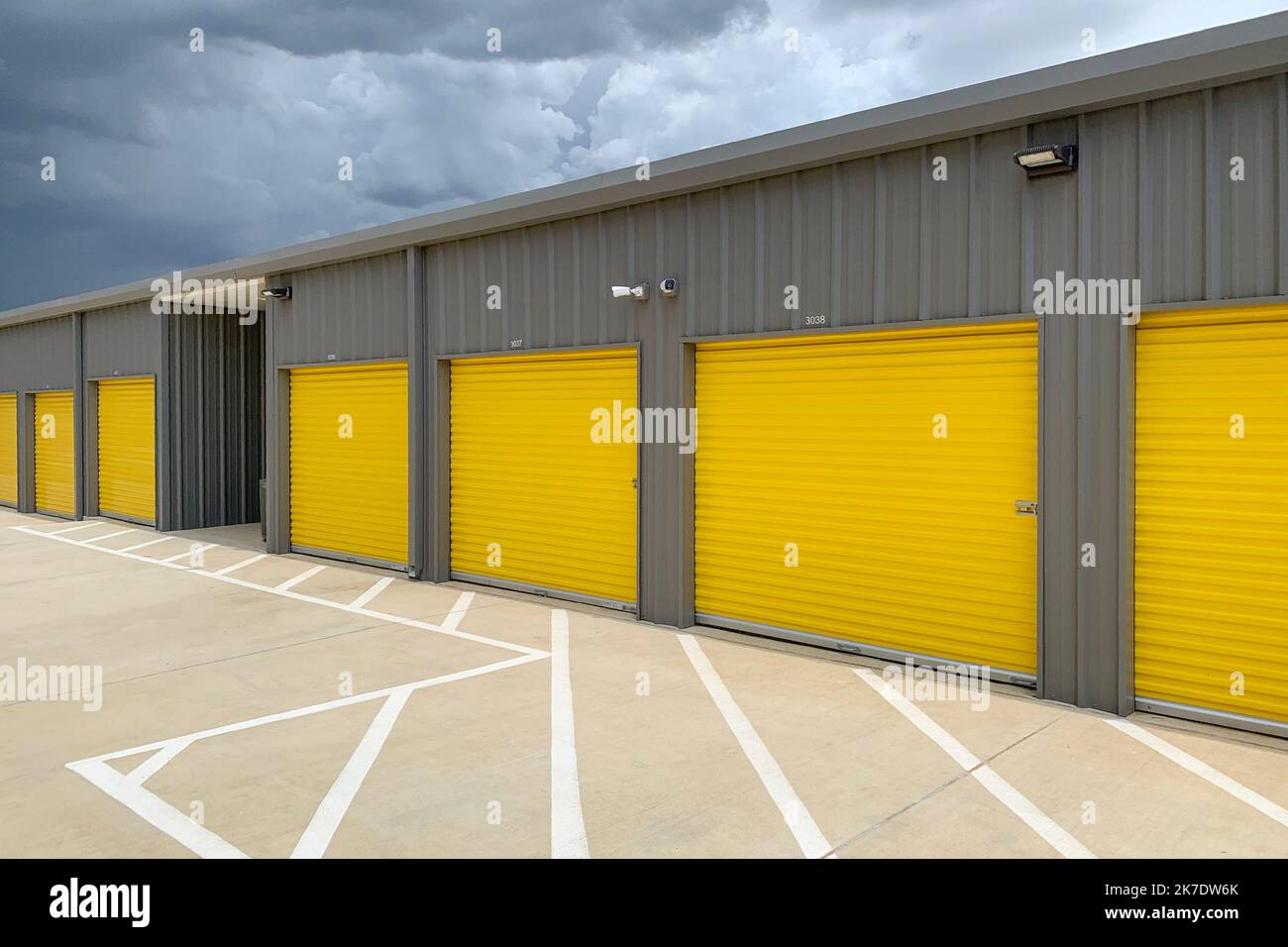 Storage unit buildings site outside, owners property. Road with