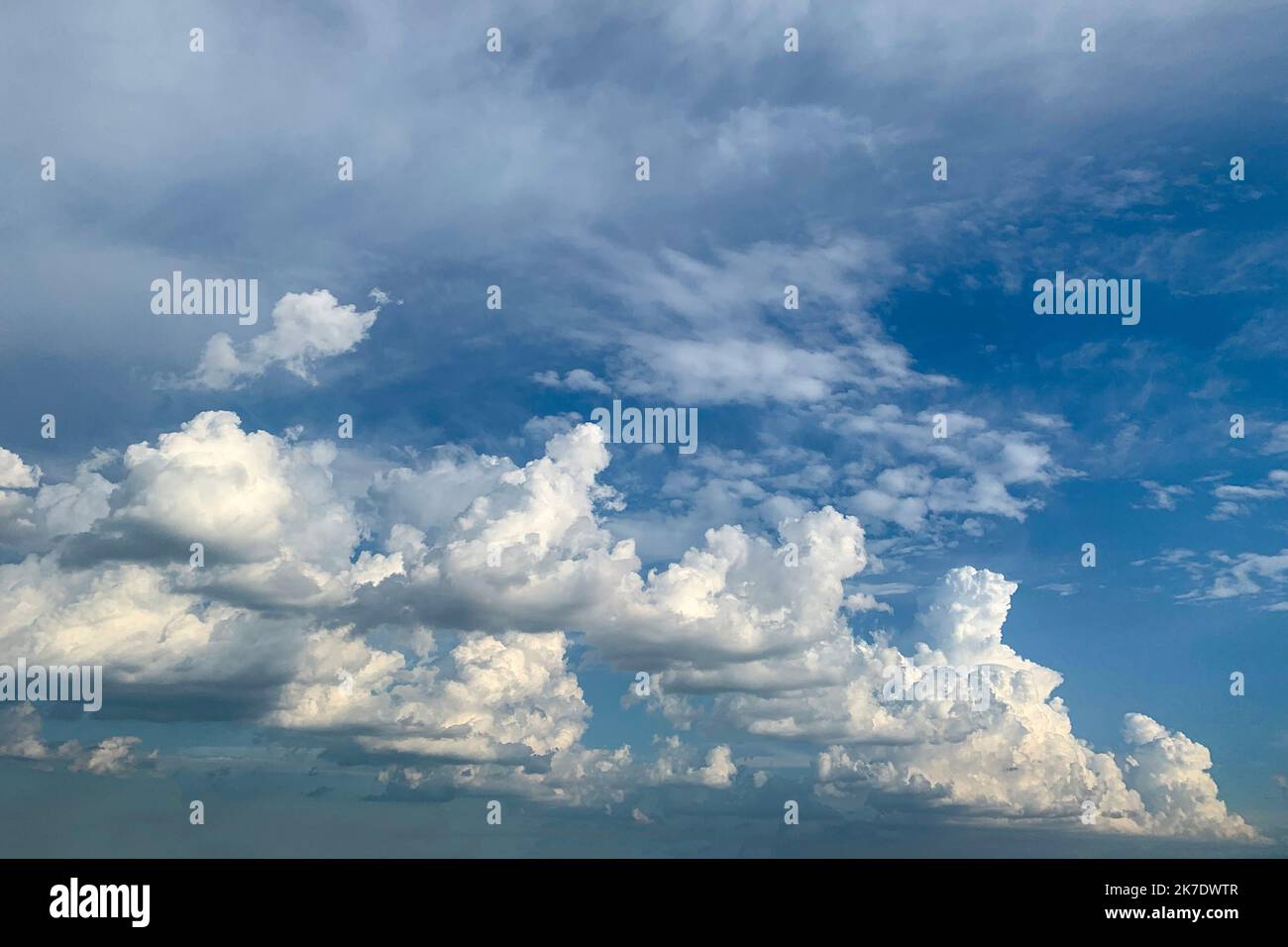 Beautiful white fluffy clouds on blue heaven background Stock Photo