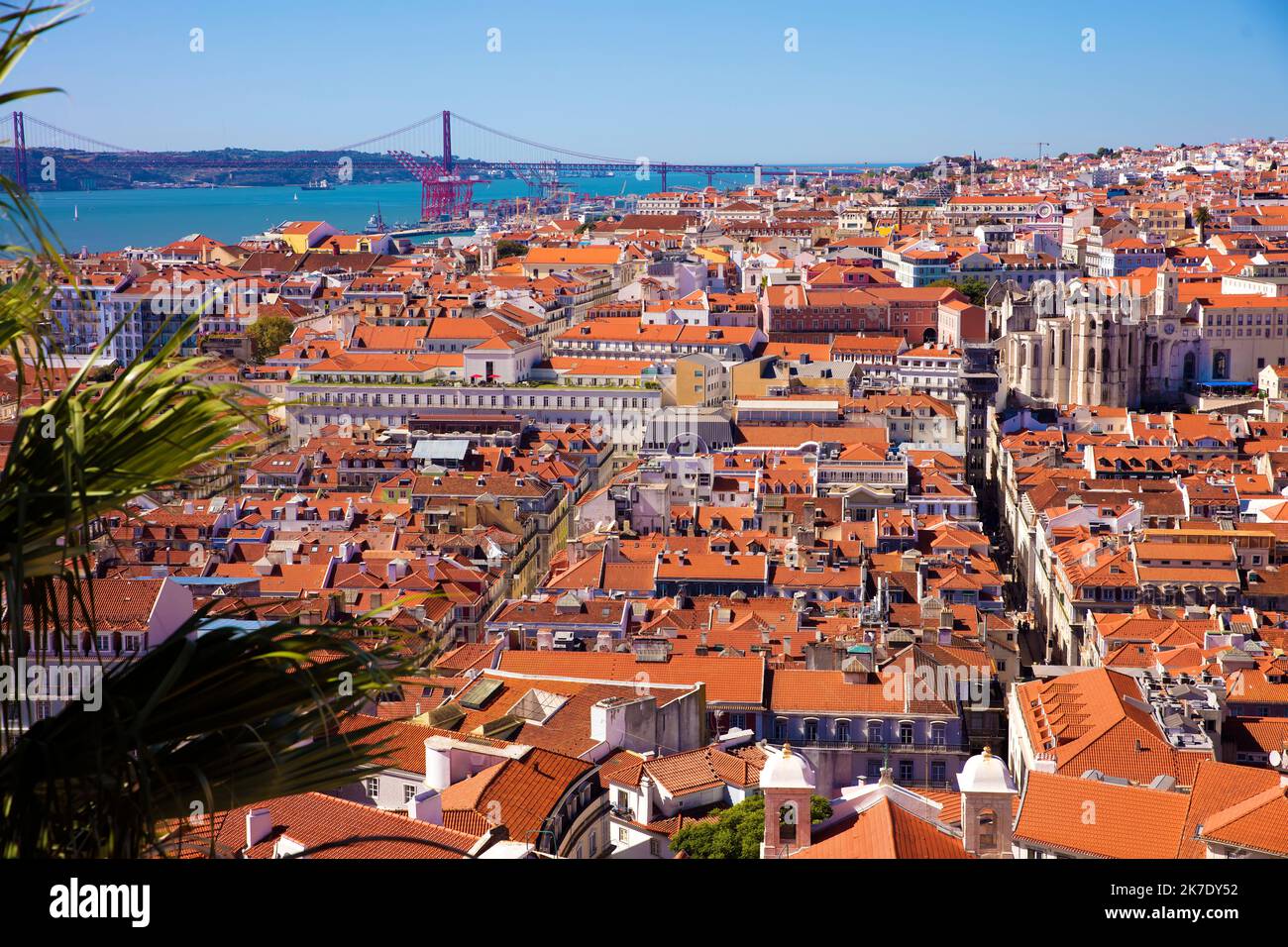 Lisbon, Portugal rooftops, River Tagus and Ponte 25 de Abril suspension bridge in panoramic view from Castelo Sao Jorge Stock Photo